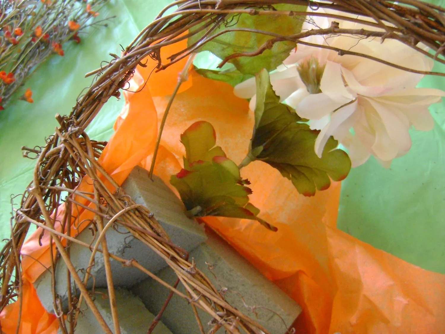 step 3 - Cut all the flowers and stems from their grouping. Arrange the flowers first by alternating colors. Push the stem into the block material and hot glue them in place.