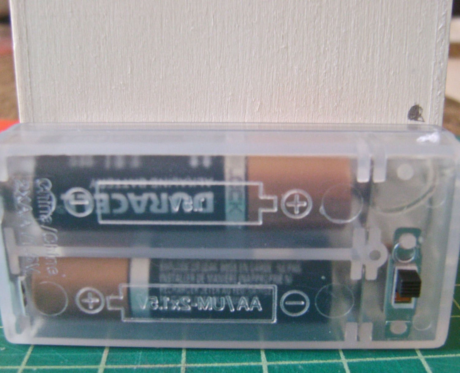step 1 - Align the battery pack to the back of the photo cube and place a pencil mark just above the battery case.
