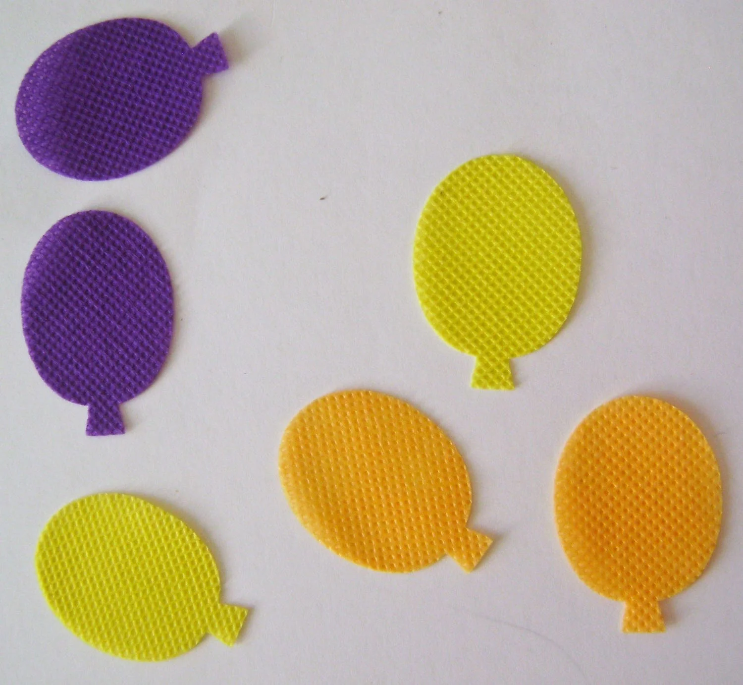 step 8 - Cut six pairs of balloon shapes in a variety of fabric colors to measure about 1.25”. Apply Turbo Tacky Glue to the perimeter of the balloons and put the matching color on top. Leave the center bottoms open 1/4”.