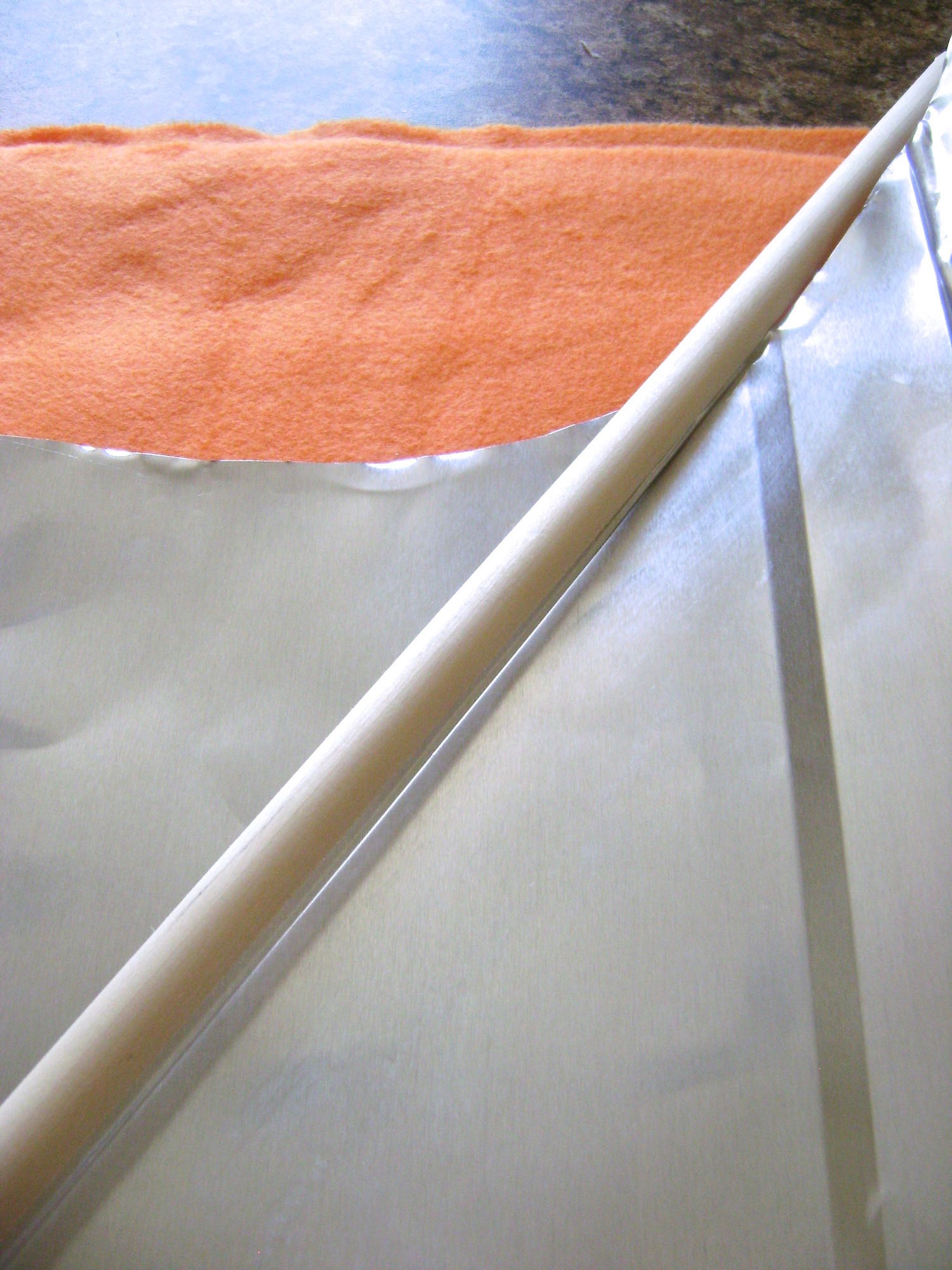 step 3 - Place a flat piece of .50” wood molding or other object against the line you created. Emboss a line along the opposite edge of the molding. Place the ruler edge on the new line and emboss a line on the opposite edge of the ruler. Continue alternating the ruler and molding, embossing lines for the basket weave until you have filled the space. 