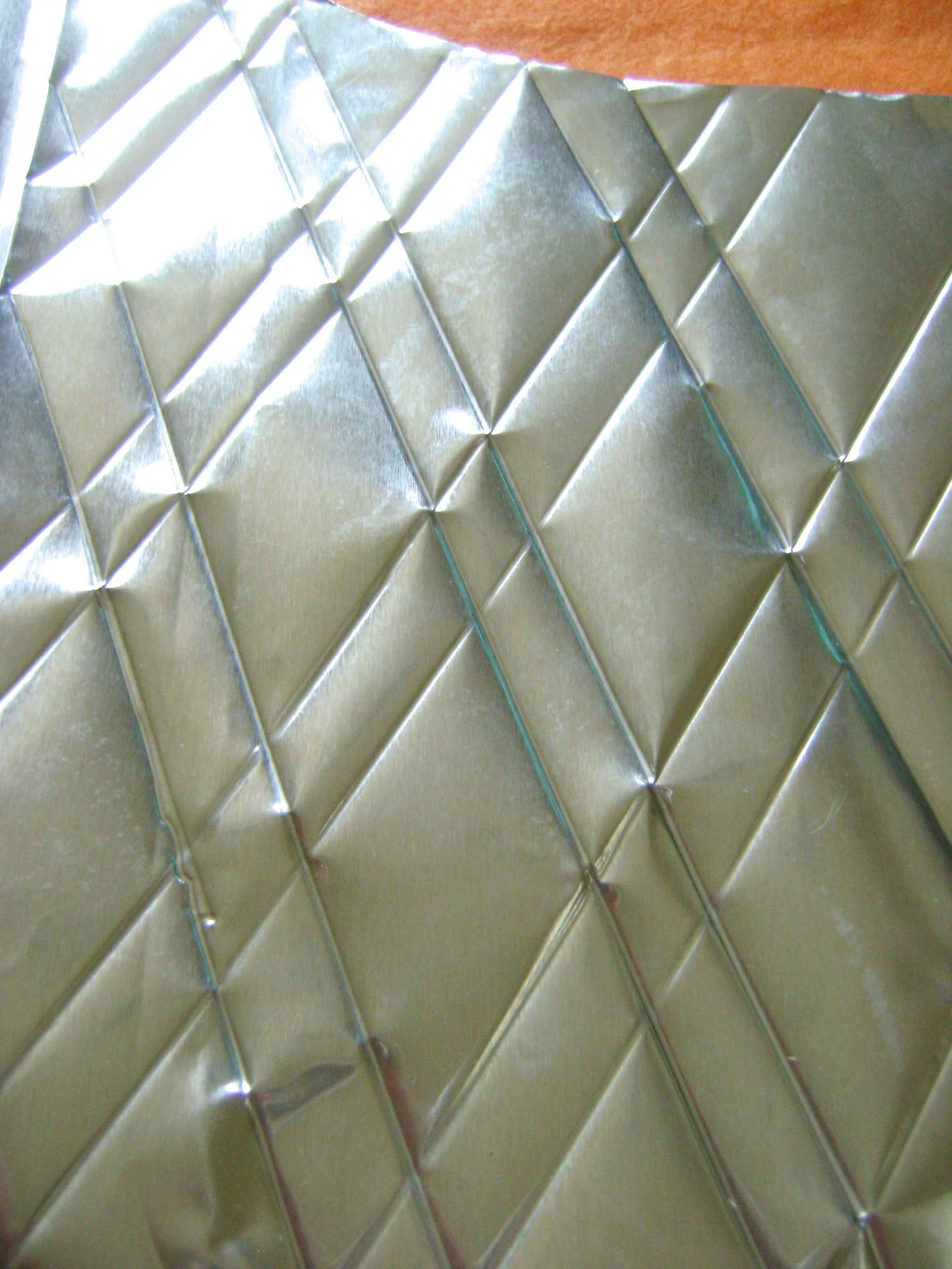 step 4 - Turn the ruler in the opposite diagonal direction and emboss lines in the same way.