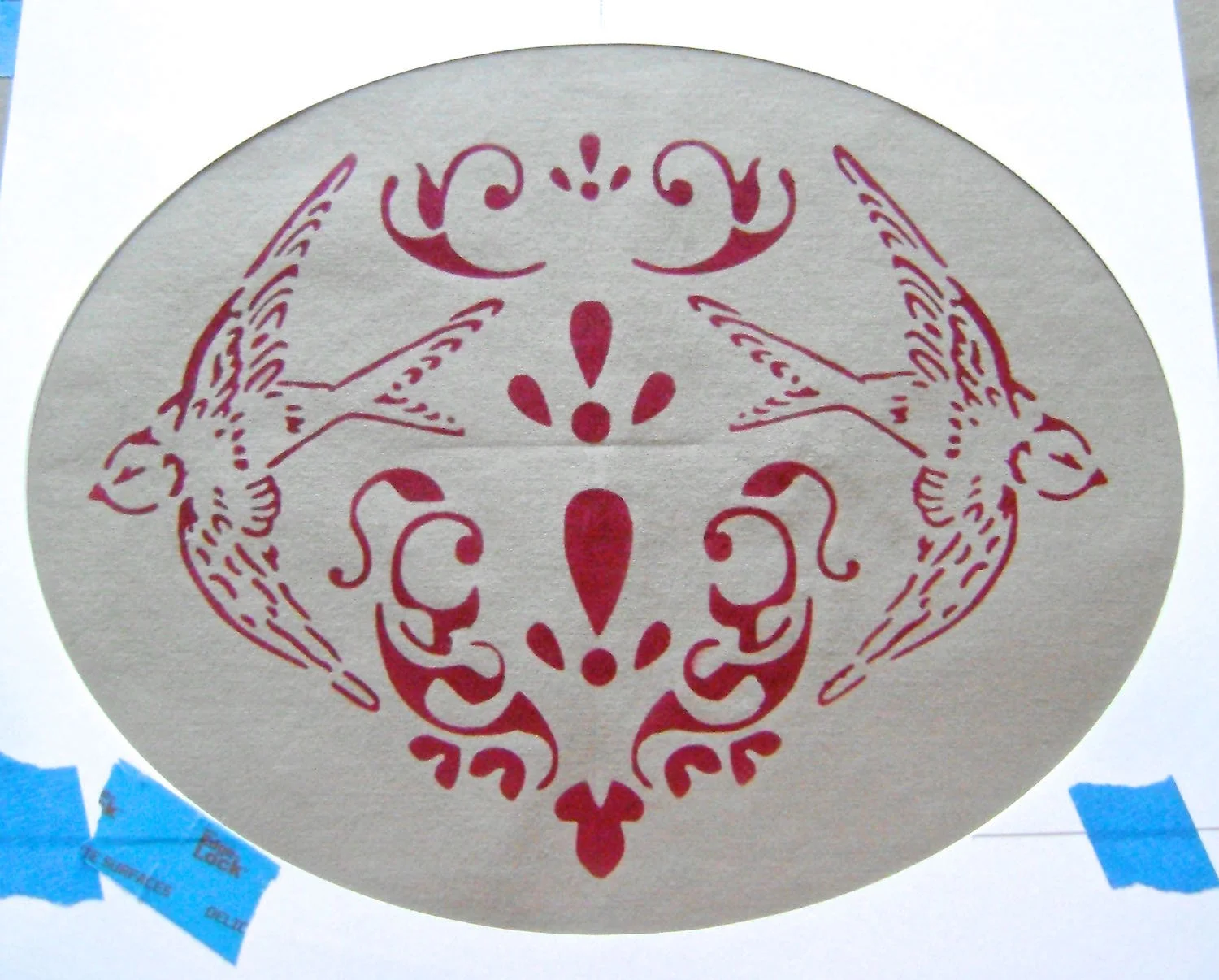 step 8 - Apply adhesive to the large oval and center it on the fabric. 