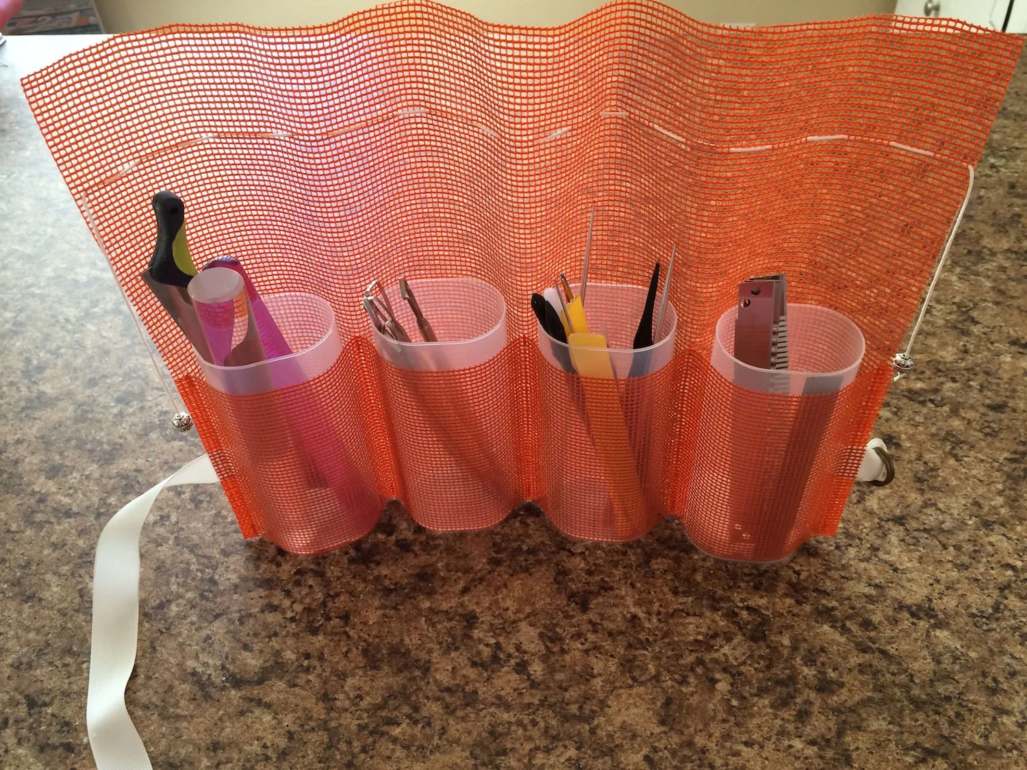 step 7 - Place the containers into the cuffs and fill them with your tools. If your tools aren’t tall enough to stick out of the top of the container, use the lid as a pattern and cut foam a little smaller than the pattern. Place it in the bottom of the container then fill it with your tools.
