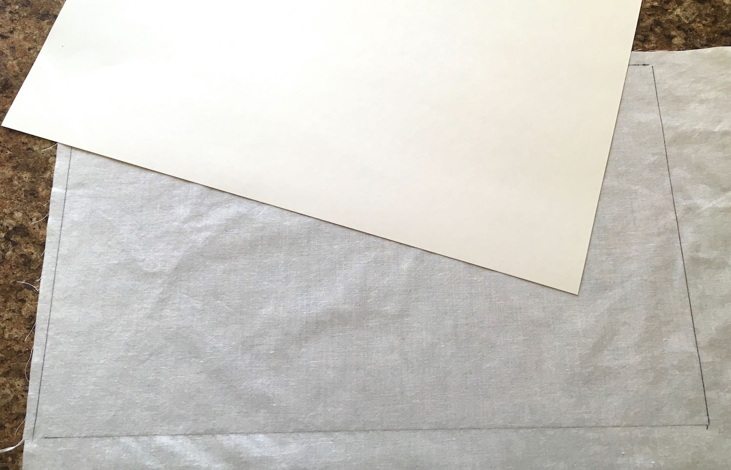 step 1 - With a pen, trace a 8.50” x 14” sheet of card stock onto white cotton.