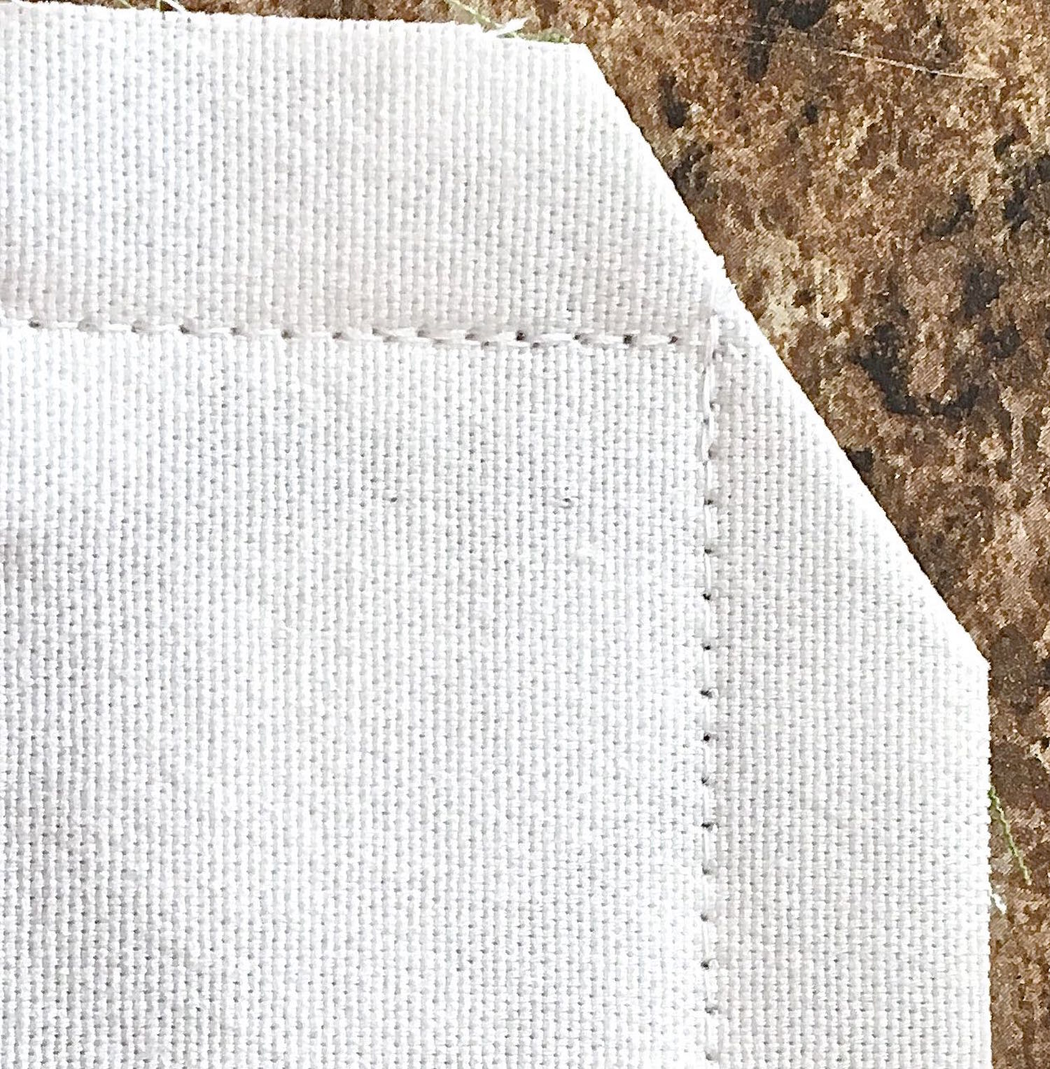 step 12 - Reinforce the corners with additional stitching. Cut across corners at an angle. Turn the pillow case right side out.