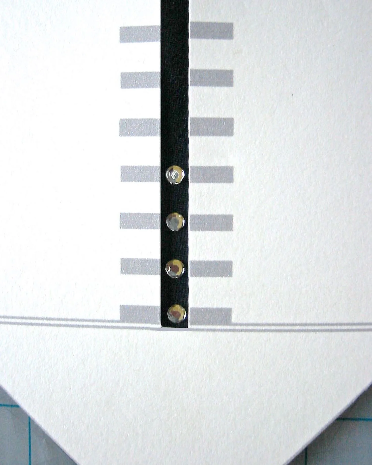 step 1 - Download the free tie template and follow the instructions on the page for joining the 3 template pieces. The template is designed to simplify the positioning of rhinestones on the tie.
