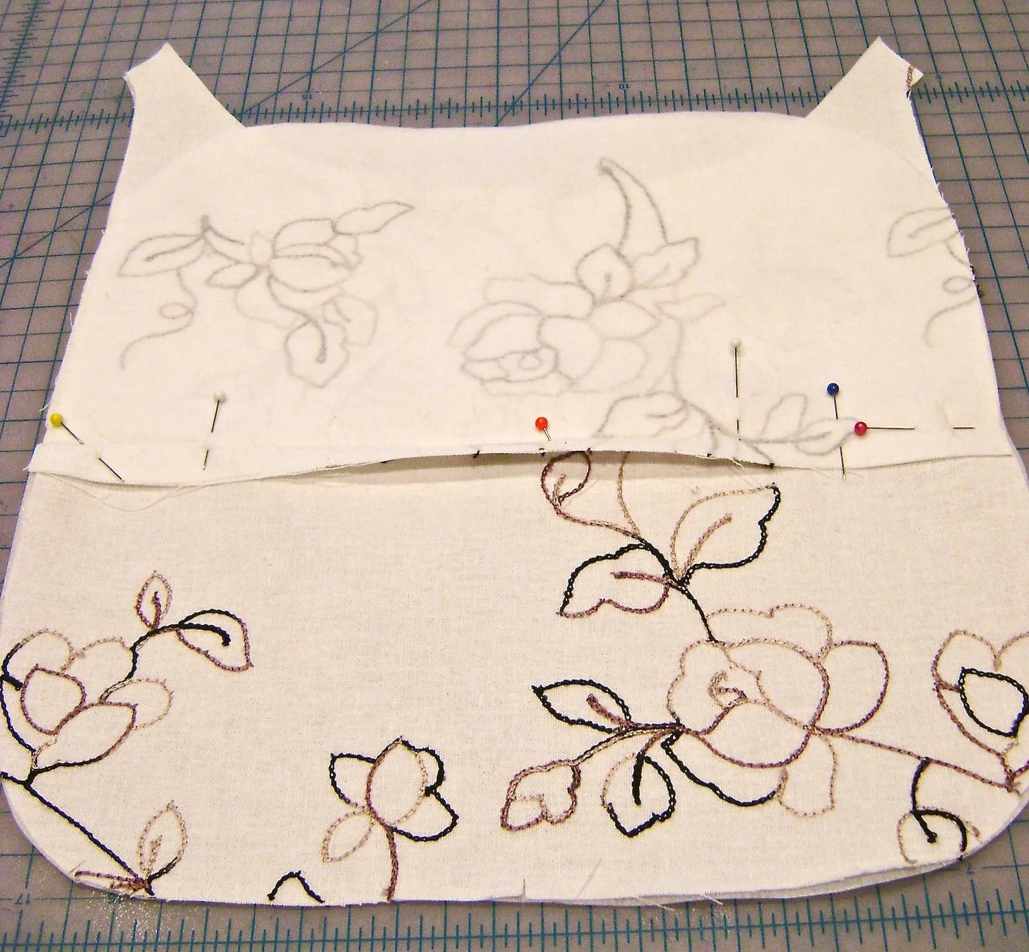 Back Zippered Pockets step 1 - Press the seam allowance on the interfaced pocket piece. Align the piece as indicated on the pattern with right sides together and the pocket above the dotted line.