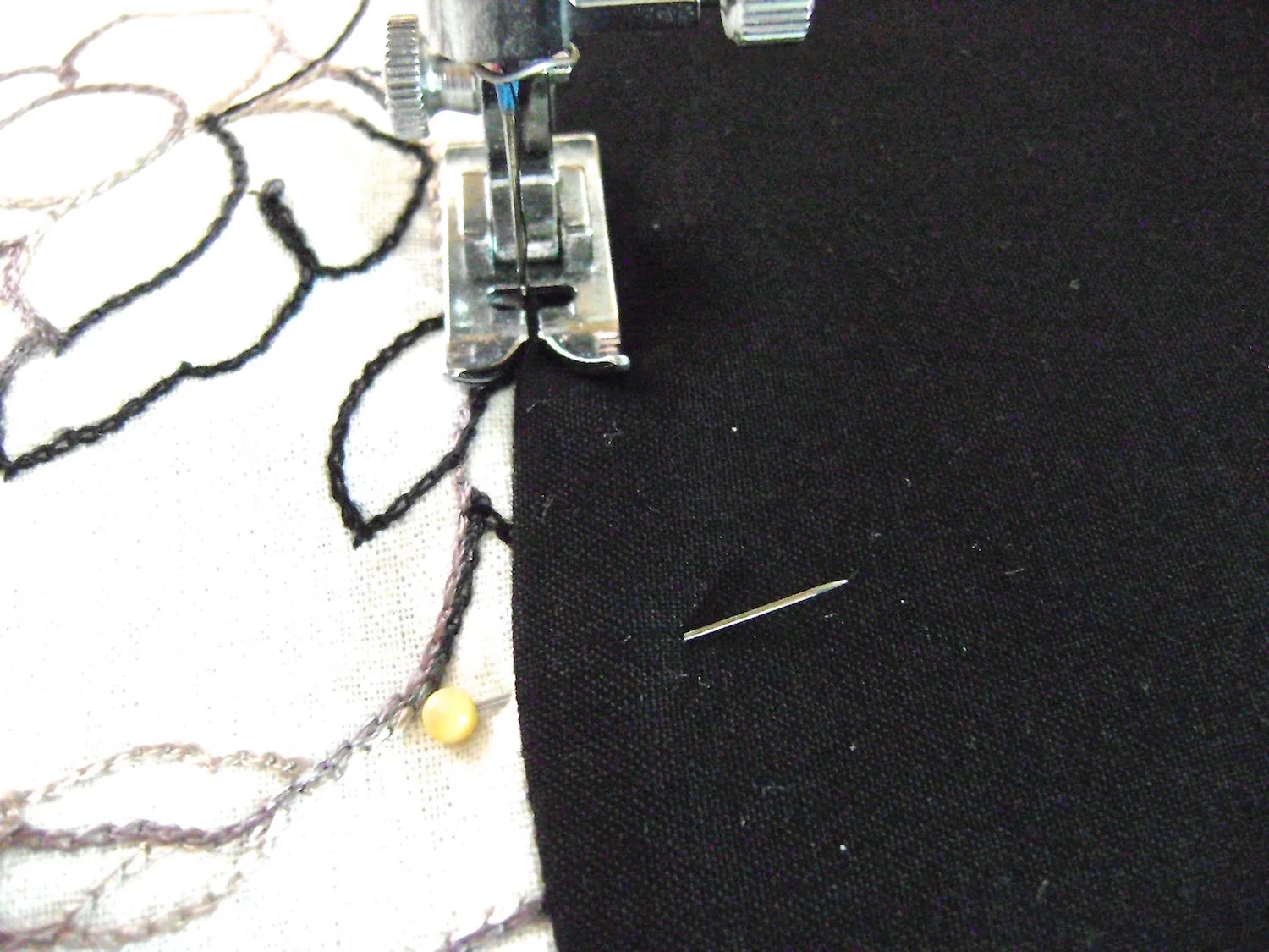 step 6 - Trap the plastic yoke inside the fabric yokes by pinning the outer fabric and lining yokes together at their bottom curved seams. Once they are aligned, hide machine stitching in the gutter of the seam to secure the pieces together. The plastic should be slightly smaller than the fabric yokes. You should not be stitching through plastic.
