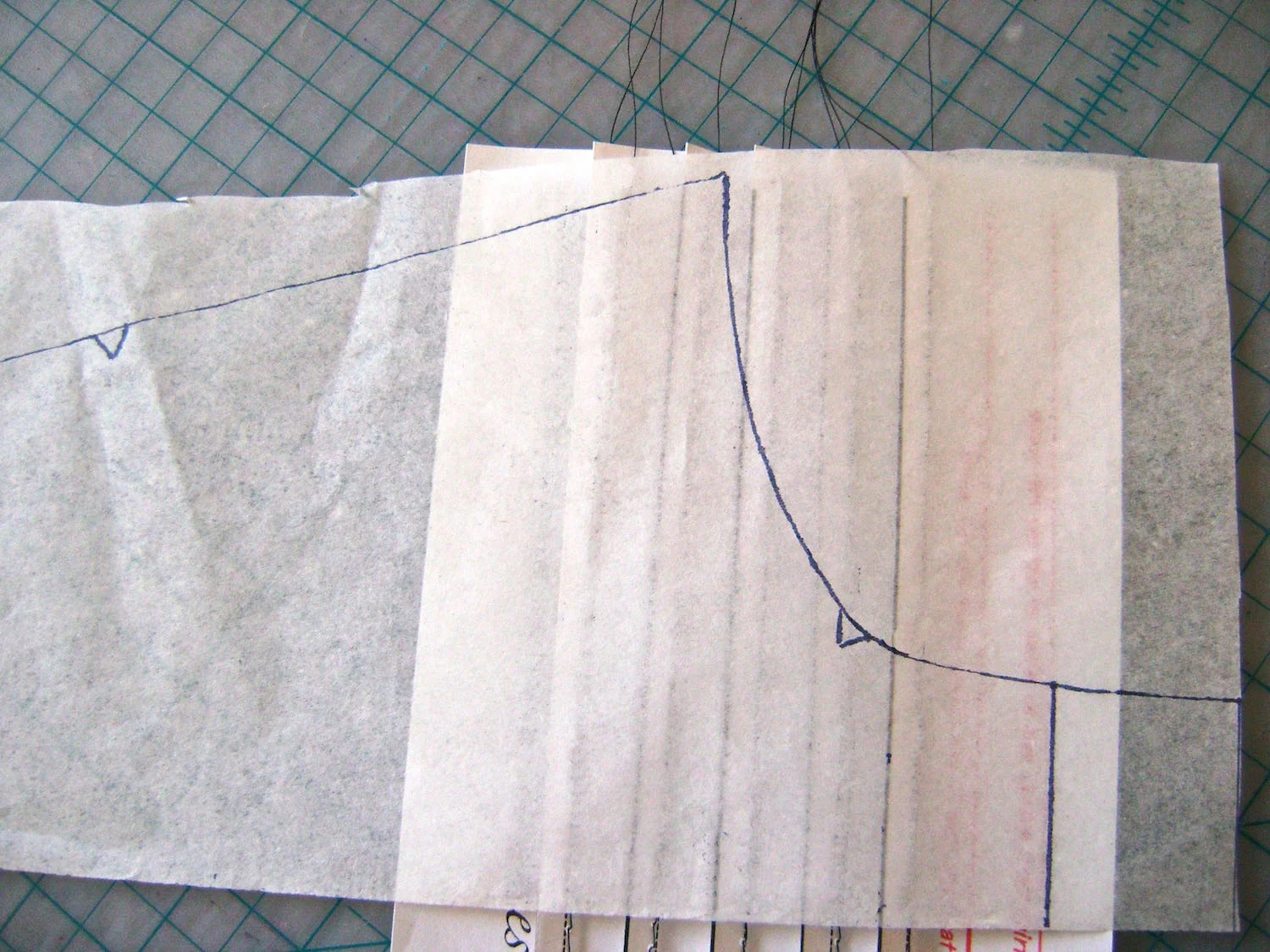 step 5 - Position your transparent paper with the traced neck edge, on top of the pleated template, matching the center lines. 
