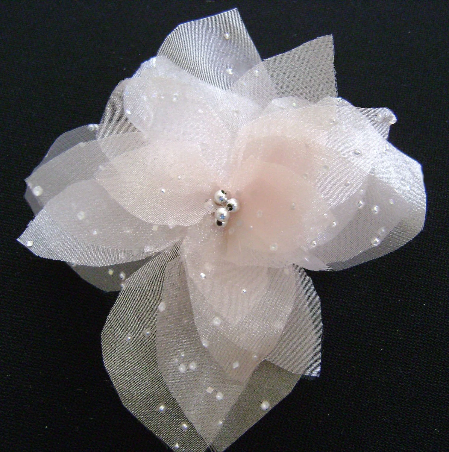 Organza dotted with silver accents. Silver bead center.