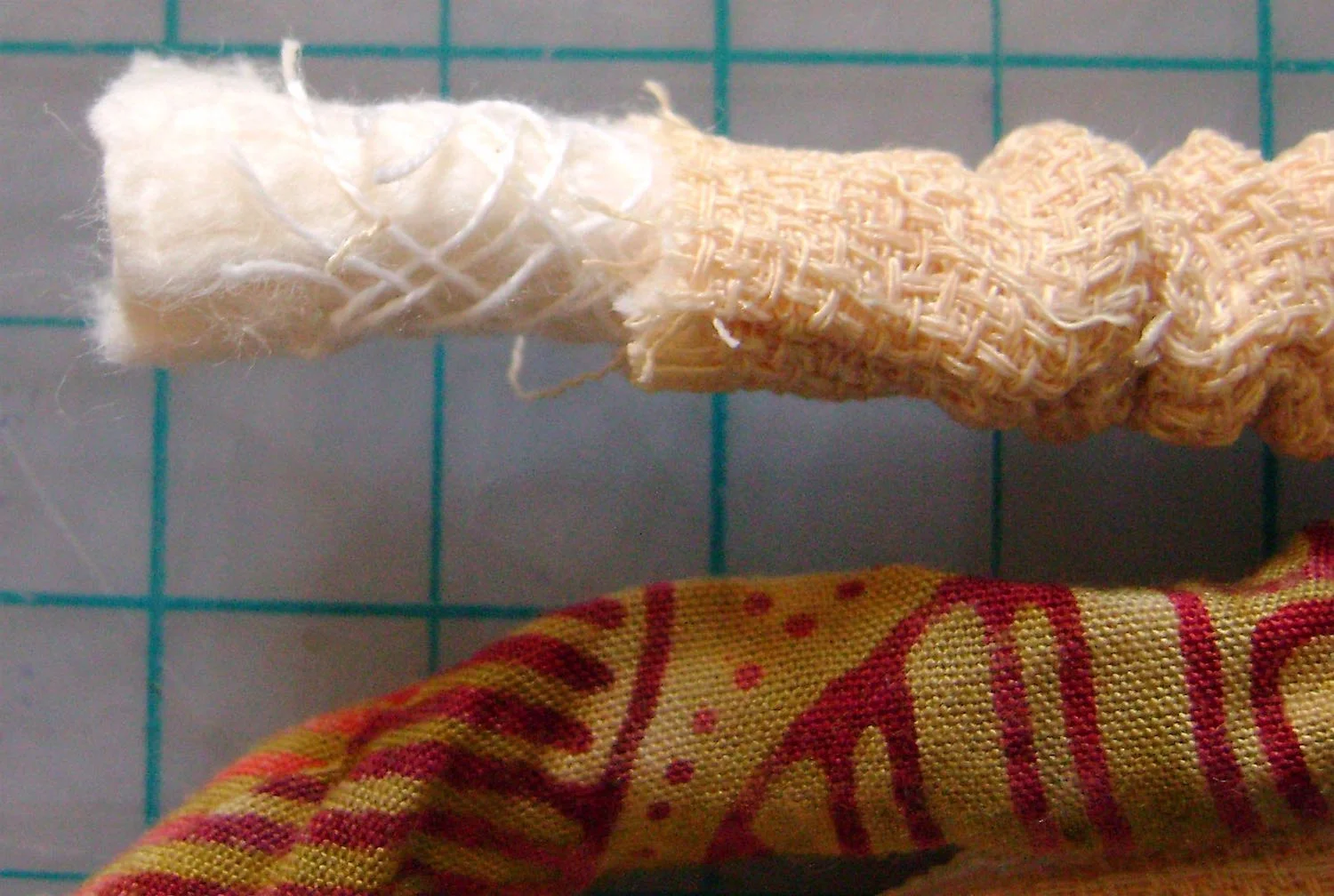 step 2 - After braiding the three strips, pull back the casings and cut off .50” of the piping from two of the braided strips on each end. This will provide an overall equal thickness when you join it with the connecting loop.