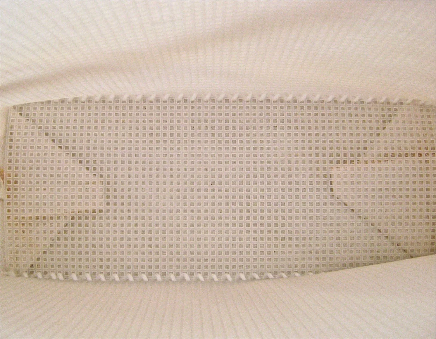 Push the mesh firmly, and all the way to the bottom until it is seated properly. 