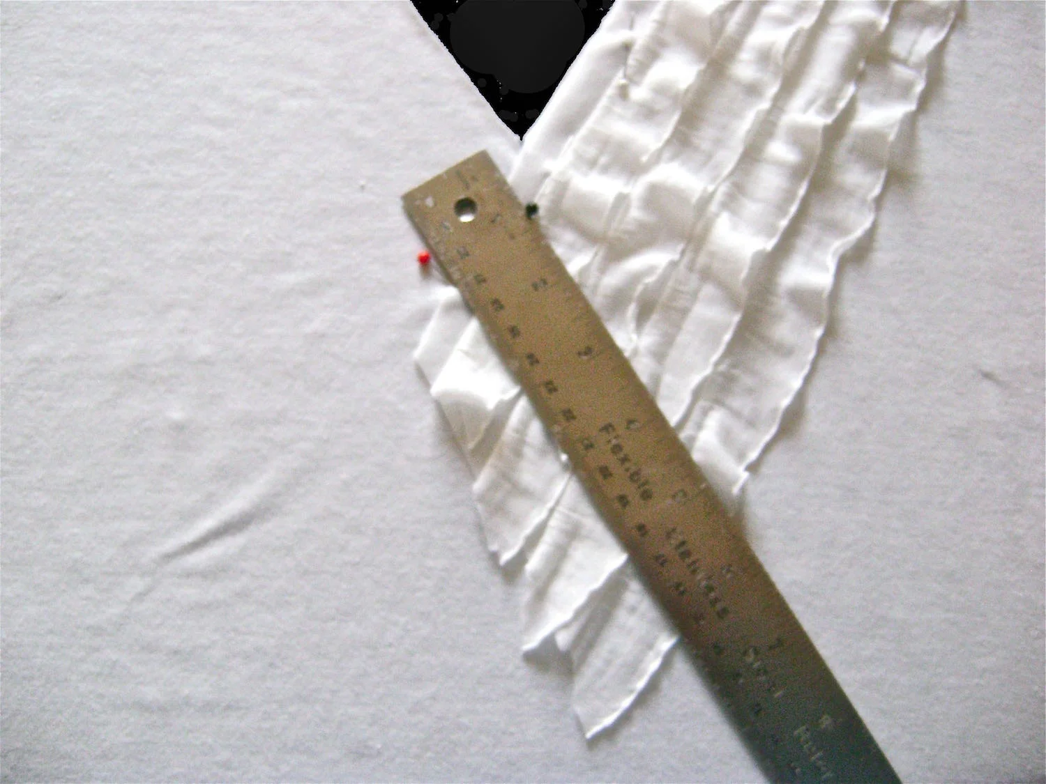 step 4 - Cut the end of the strip at an angle so that it overlaps the center crease by about 2”.