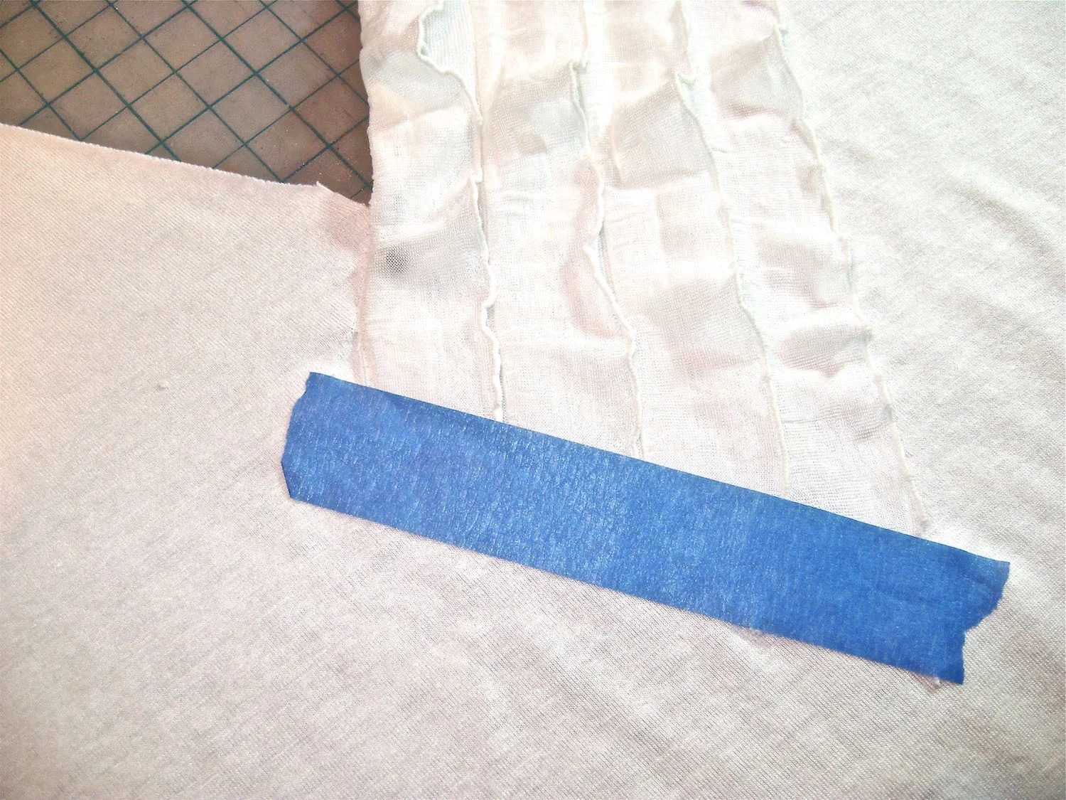step 8 - Use painters tape to secure the loose ruffle edges to the shirt.