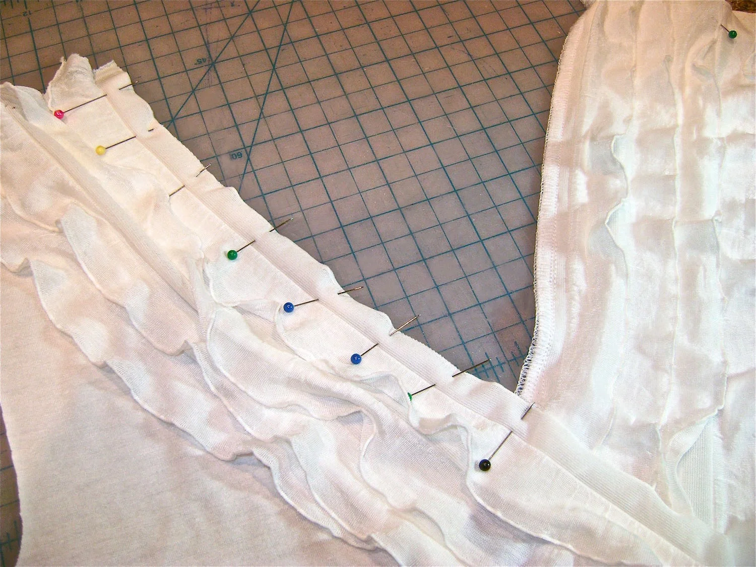 step 9 - Pin the right side ruffle strip to right side of shirt front. Follow steps 5 & 6. At the end of the stitching, cut a little less than a ½” slit in the flat margin which will allow it to be turned under. 