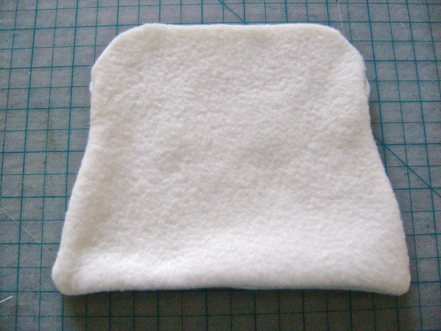 step 4 - Sew the fleece side seams together only to the side opening notch. Sew the bottom seam with 1/4” allowance, then turn the fleece right side out with the raw edges inside.