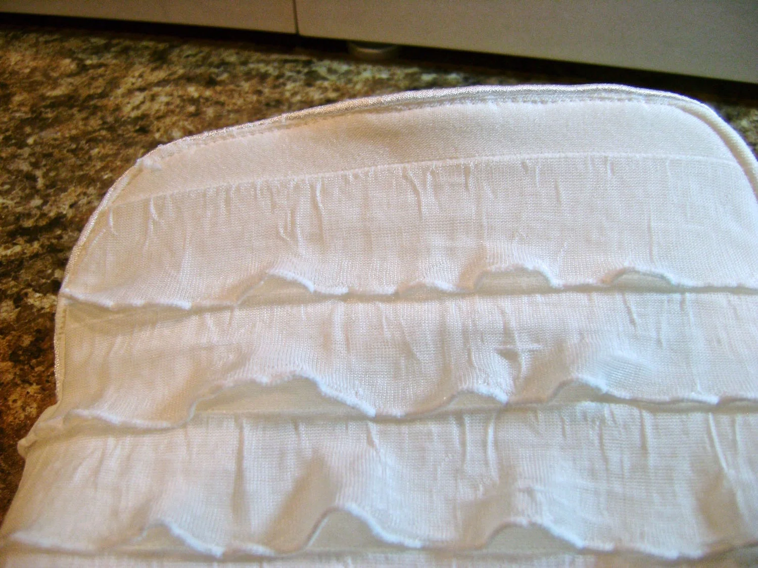 step 11 - Turn the purse right side out. Slip stitch or machine sew the opening in the lining bottom. Tuck the lining inside the purse. Top stitch around the top and sides of the purse opening 1/8” from the edge.