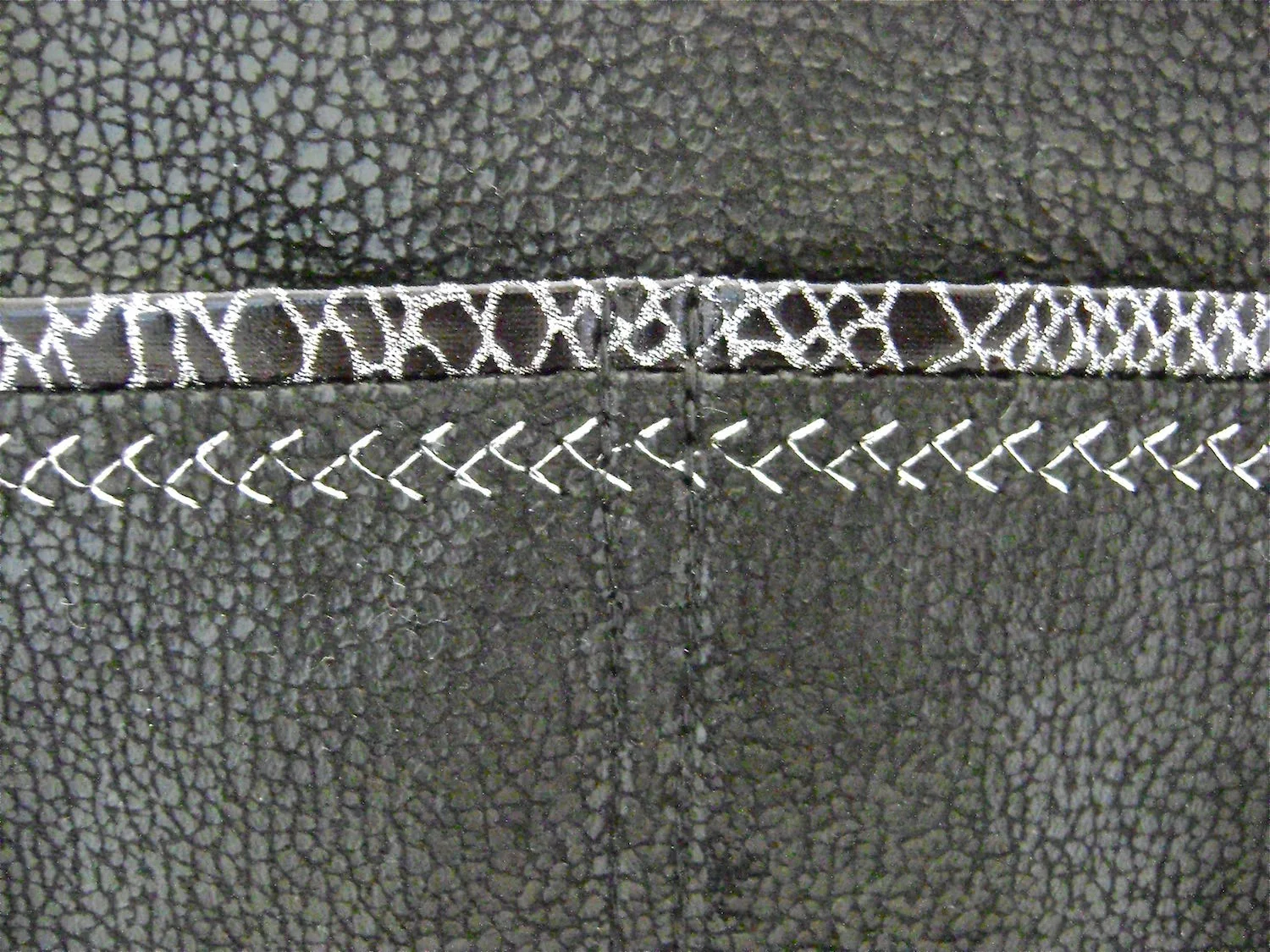 step 11 - Baste the pocket to the purse front. Double stitch vertically from the pocket top to bottom in the center of the purse. Divide the spaces to the left and right equally and double stitch again, resulting in four individual pockets.