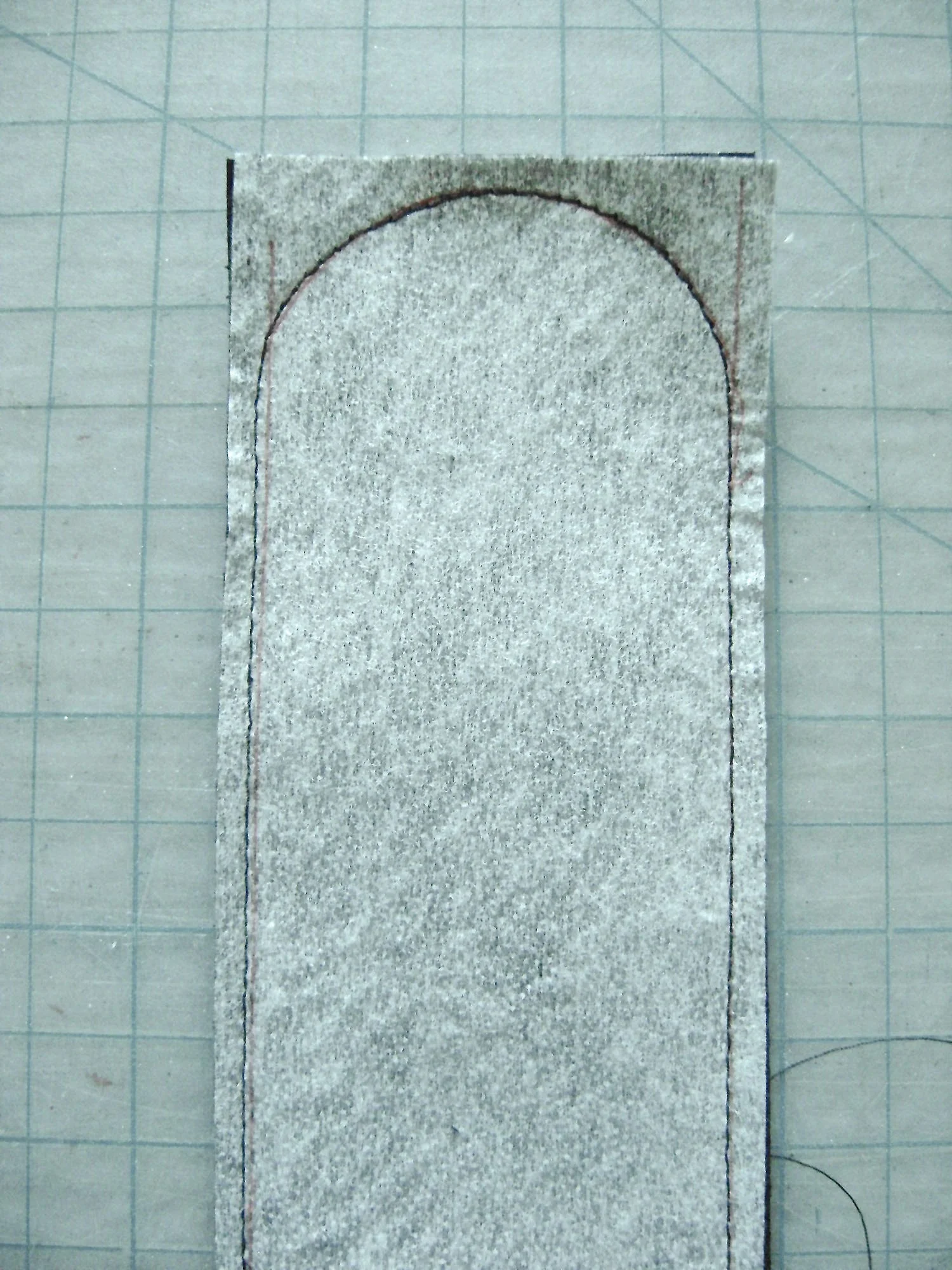step 25 - Create the two loops by sewing the snakeskin fabric to the black fabric with right sides together. Leave one end open. Shape the other end into a curve. Trim and turn right side out.