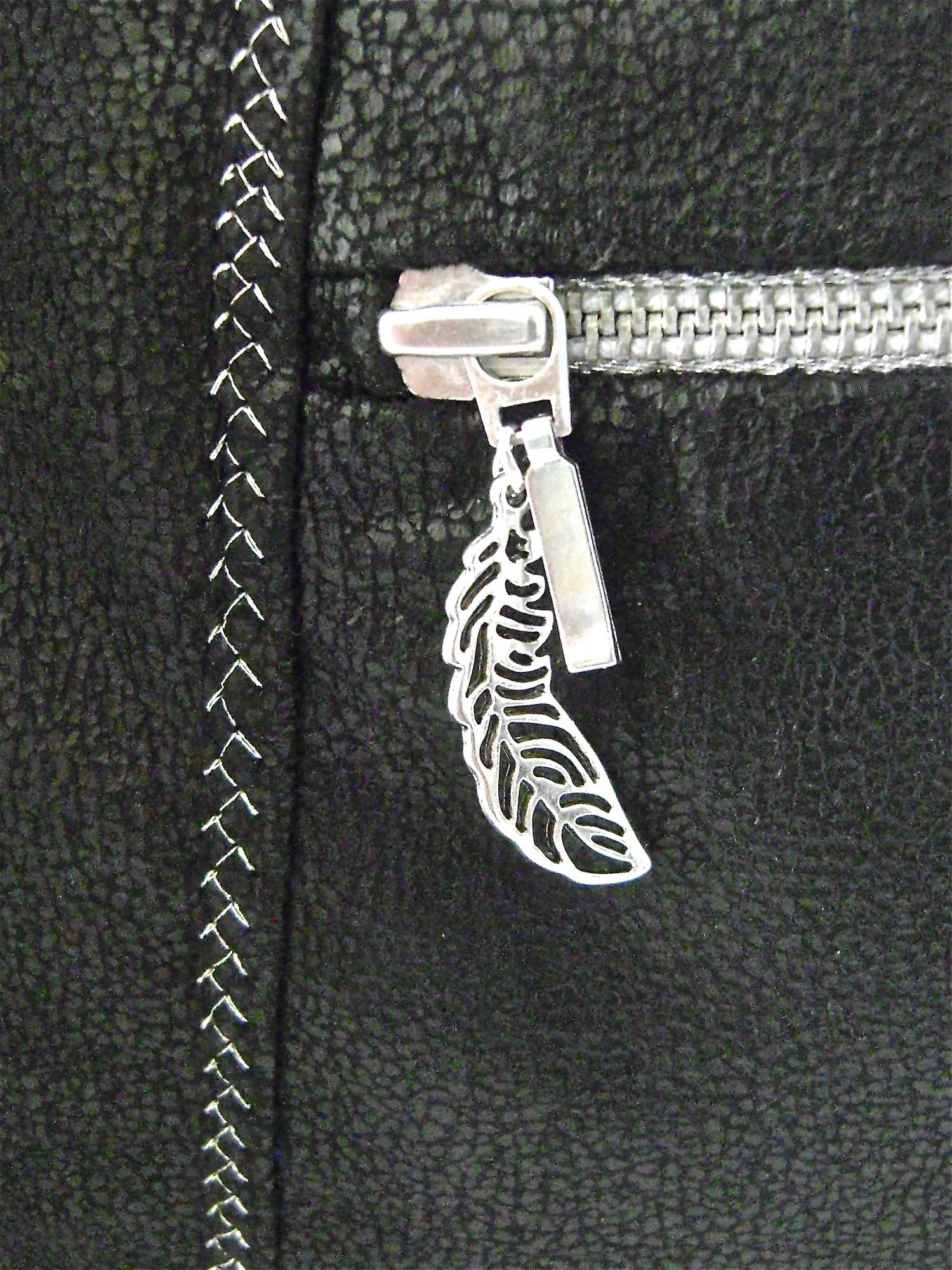 step 40 - Attach a special silver leaf charm to the zipper pull.