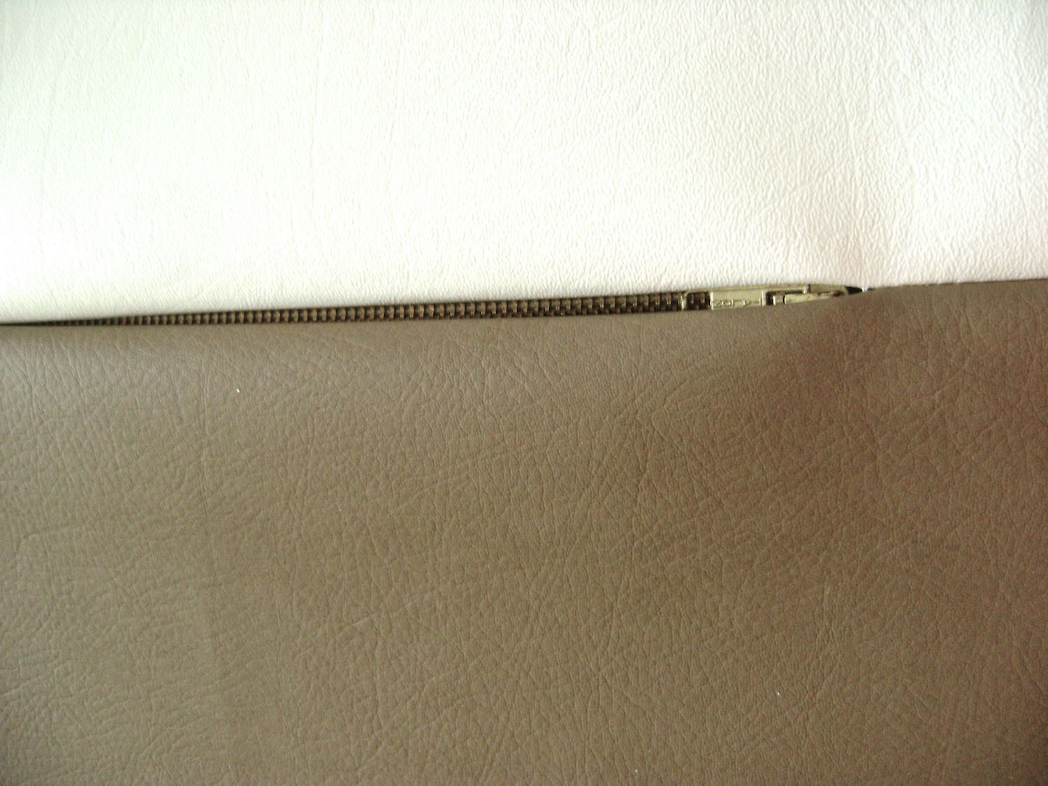 step 4 - Lay the vinyl flat with the zipper face up. Use painters tape to hold the edges together and flat.