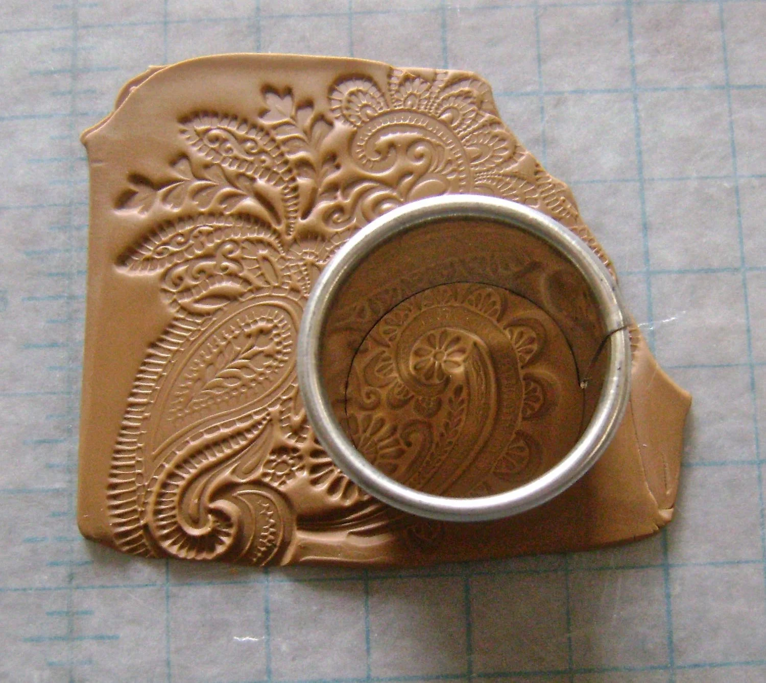 step 22 - Use a cookie cutter to cut out two round pieces large enough to cover the magnetic clasp hardware. Bake in a 275 degree oven for 30 minutes. Cool thoroughly. With a brush, apply a thin coat of Diamond Glaze over the clay. When the glaze is dry, glue the pieces over the clasp hardware with Dazzle Tac.