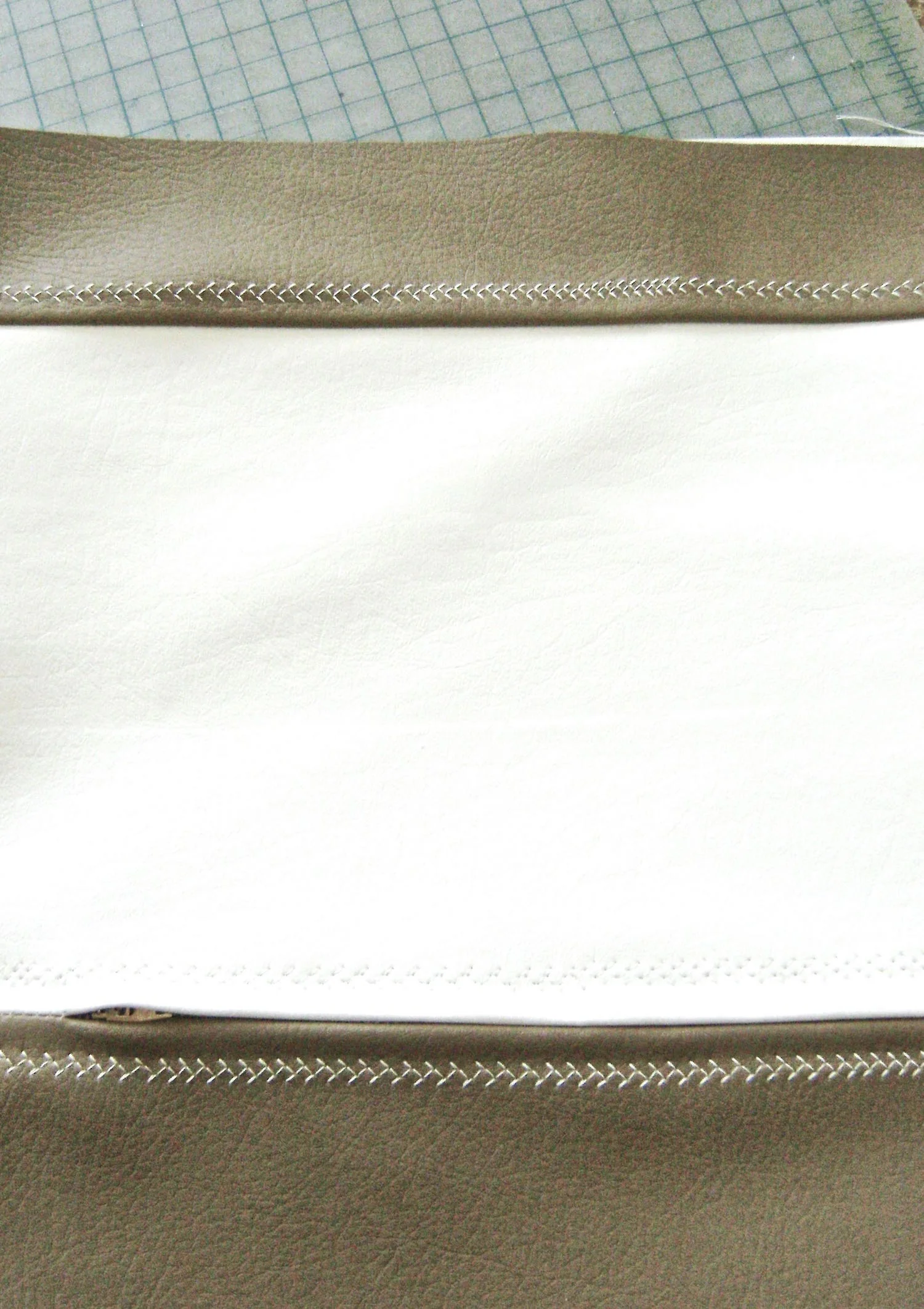step 14 - Sew the short ends of the two facing pieces with right sides together. Sew the right side of the facing to the right side of the bag. Top stitch the seam with a feather stitch.