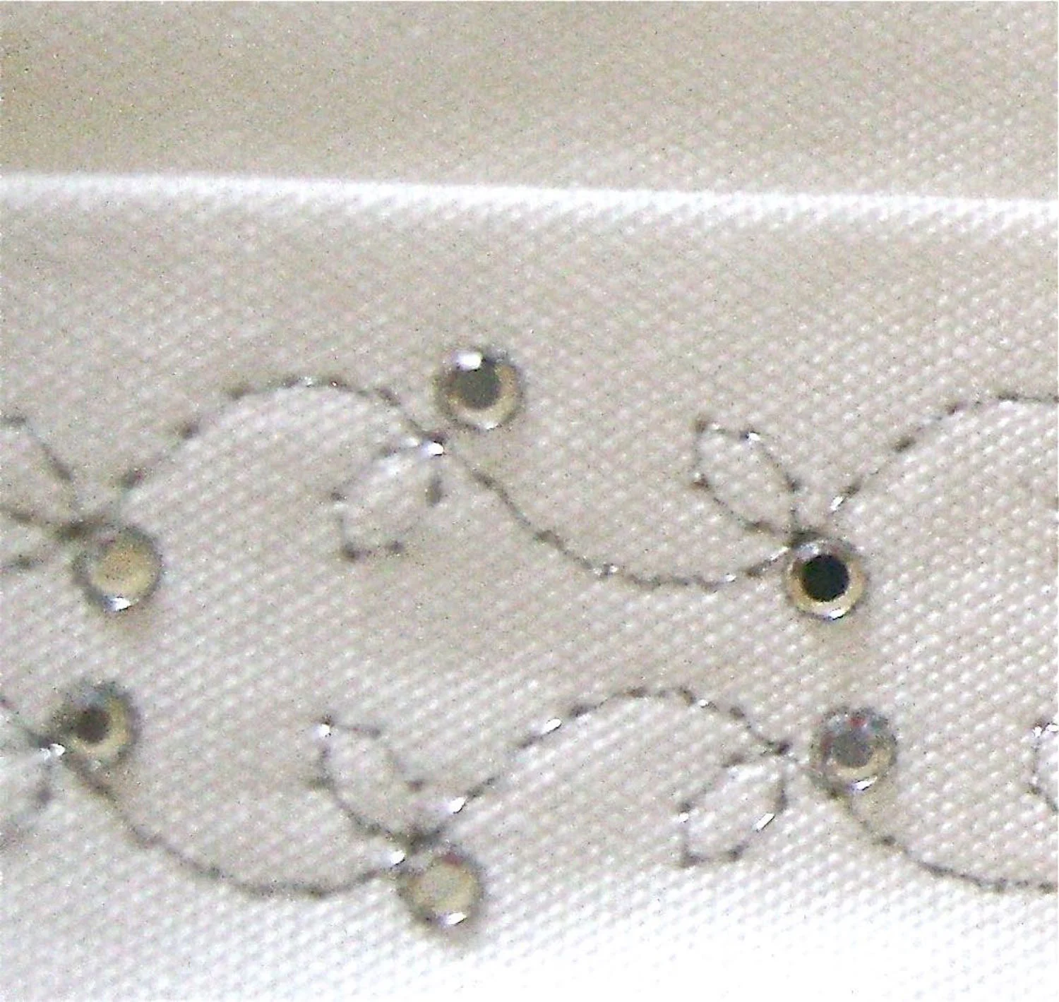 step 8 - Use a rhinestone applicator to attach stones opposite the leaves in the vine design.