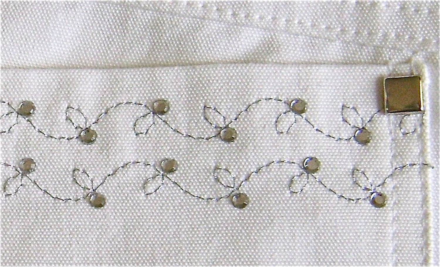 step 9 - Sew the pockets to the pants with two rows of stitching. Attach a stud to the upper pocket corners.