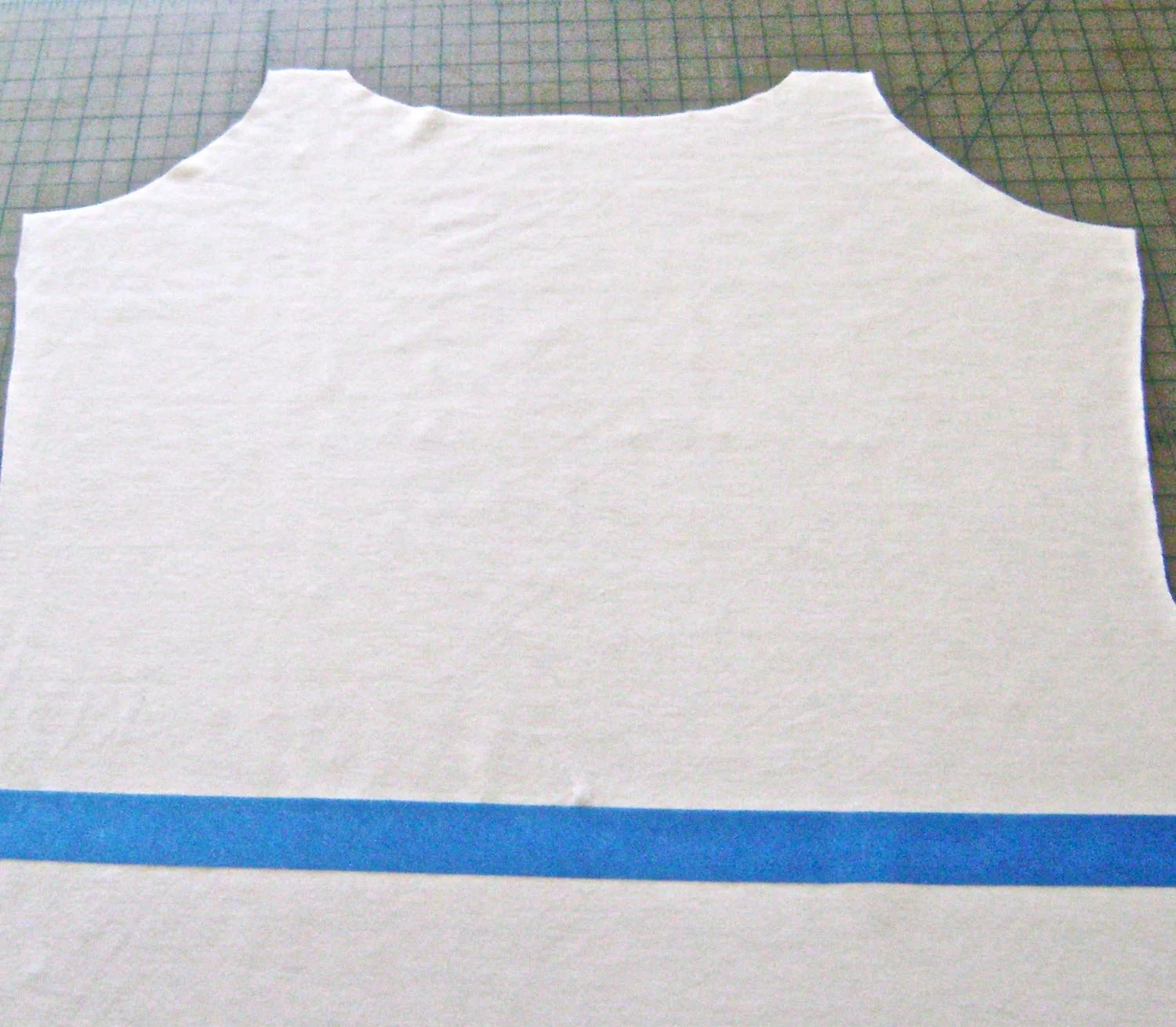 step 2 - Cut out the front and back pieces of your dress. Mark the natural waistline on the fabric pieces with painters tape stretching from one side seam to the other. This will help you align the stencil straight across the fabric in step 4. Also cut small notches for matching the waistline on both pieces when it's time to sew them together.
