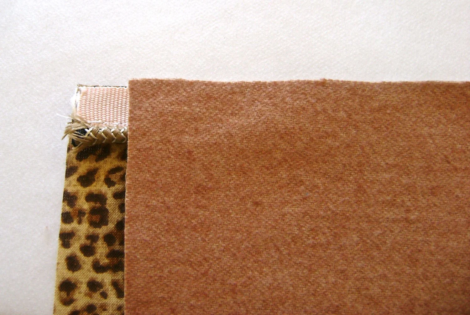 step 3 - Align the edge of the pocket lining to the edge of the piping with vinyl and right side of lining facing each other. Sew as close to the piping as possible.