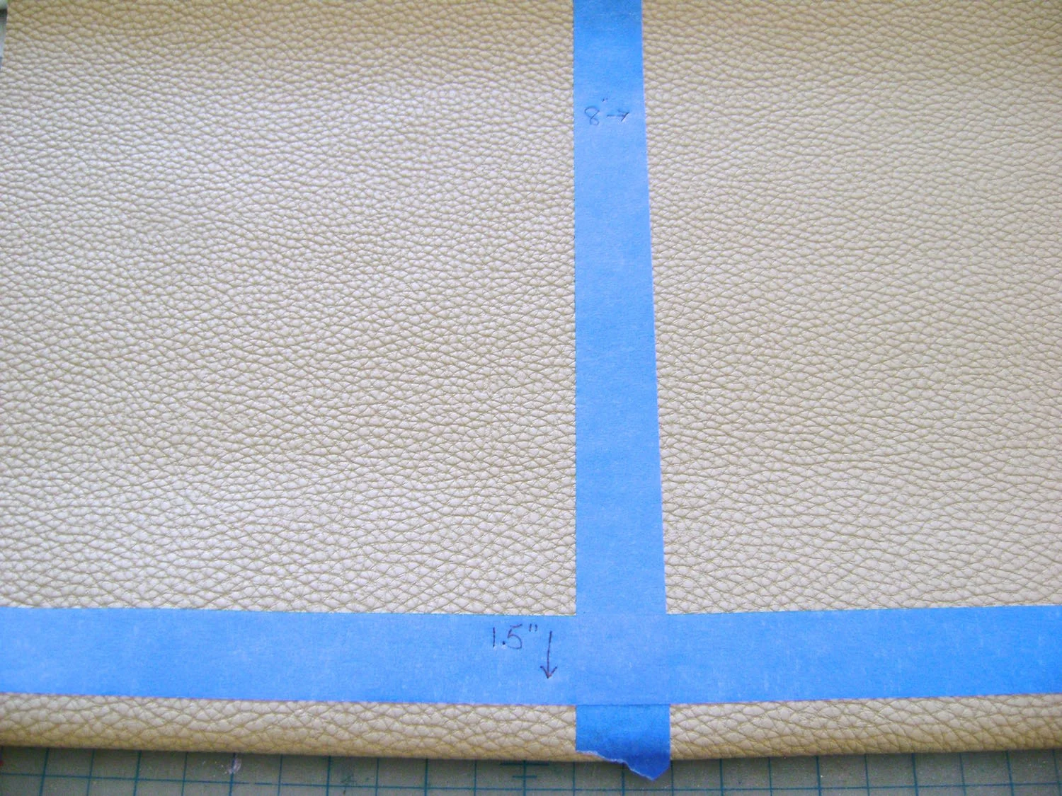 step 5 - Use painters tape to mark the vertical center of the 16" vinyl as well as the horizontal line at the 1.50” mark.
