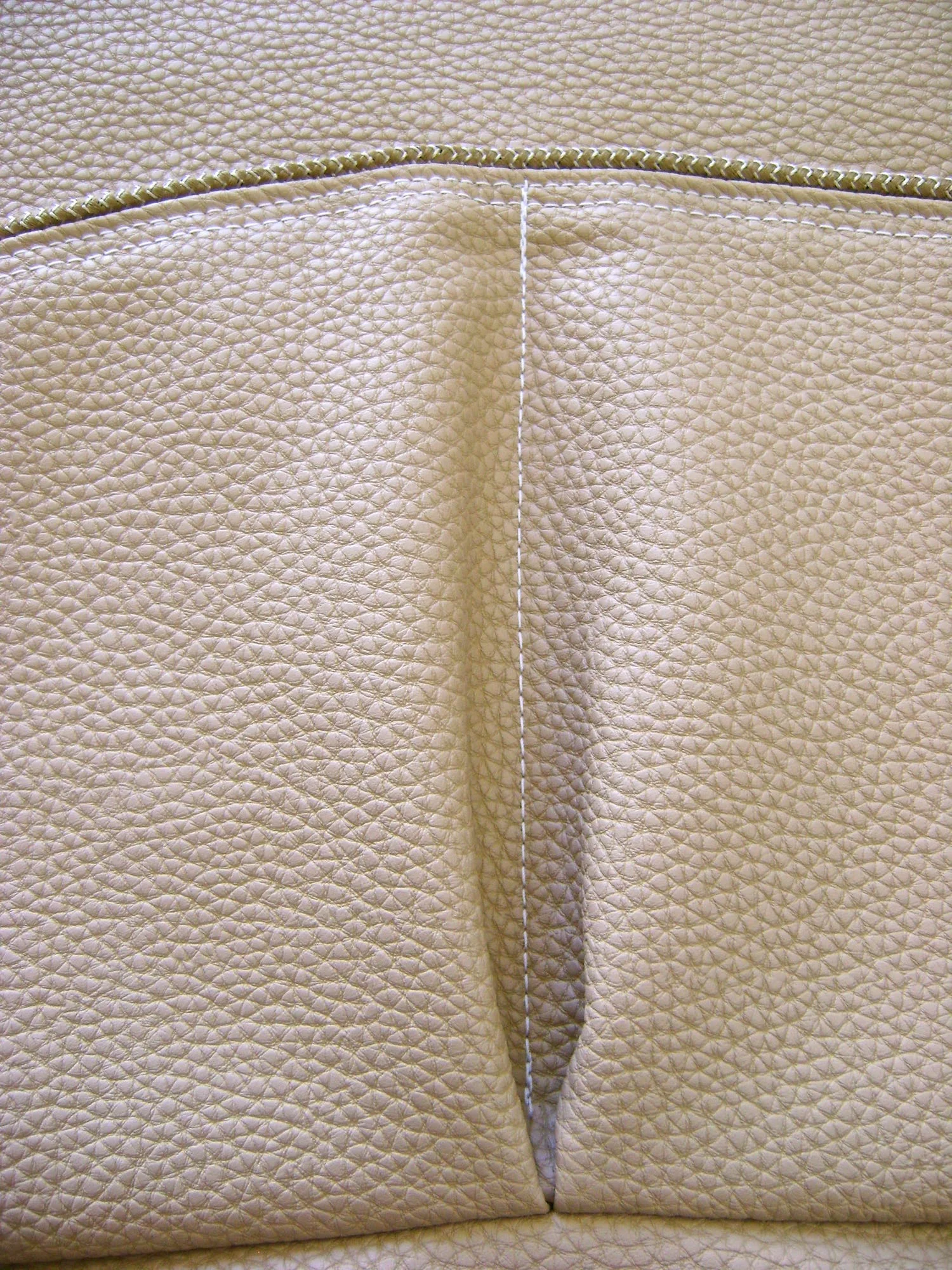 step 10 - Using the needle holes as your guide, sew the pocket to the bag center front as far down as possible with the pocket lining against the right side of the vinyl.
