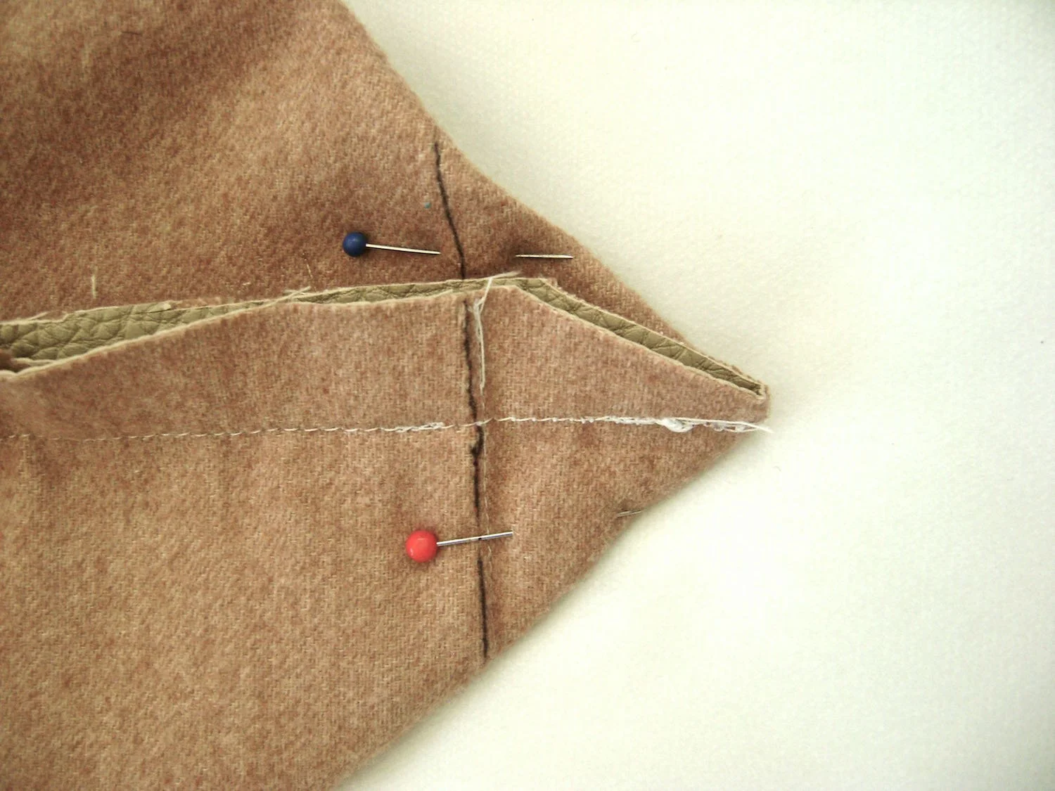 step 13 - Spread out the bottom corners to form a point with 1.50" on each side of the seam line. Use a marker to define the line which should be 3" long. Sew across the line, and again to reinforce it.