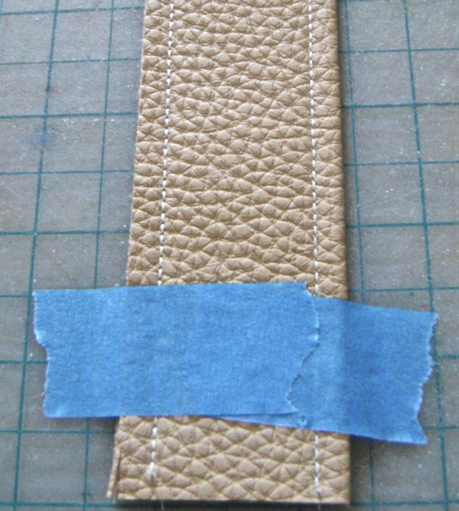 step 18 - Tape each strap to a cutting mat to align it and get an accurate trim of both side edges.