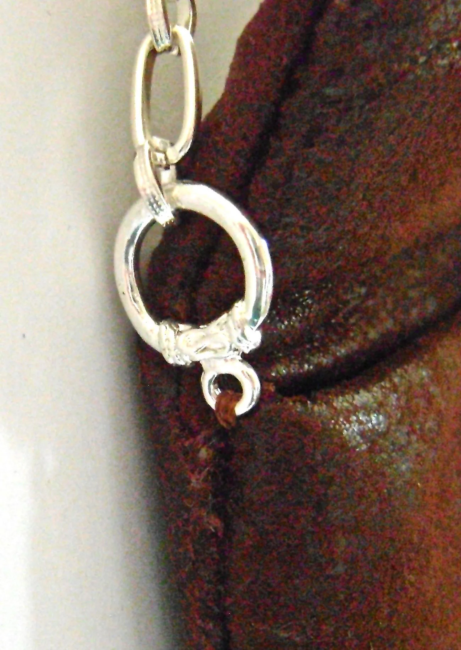 step 30 - Hand sew the round end of a toggle clasp to each top side edge of the purse. Attach chain to the clasp.
