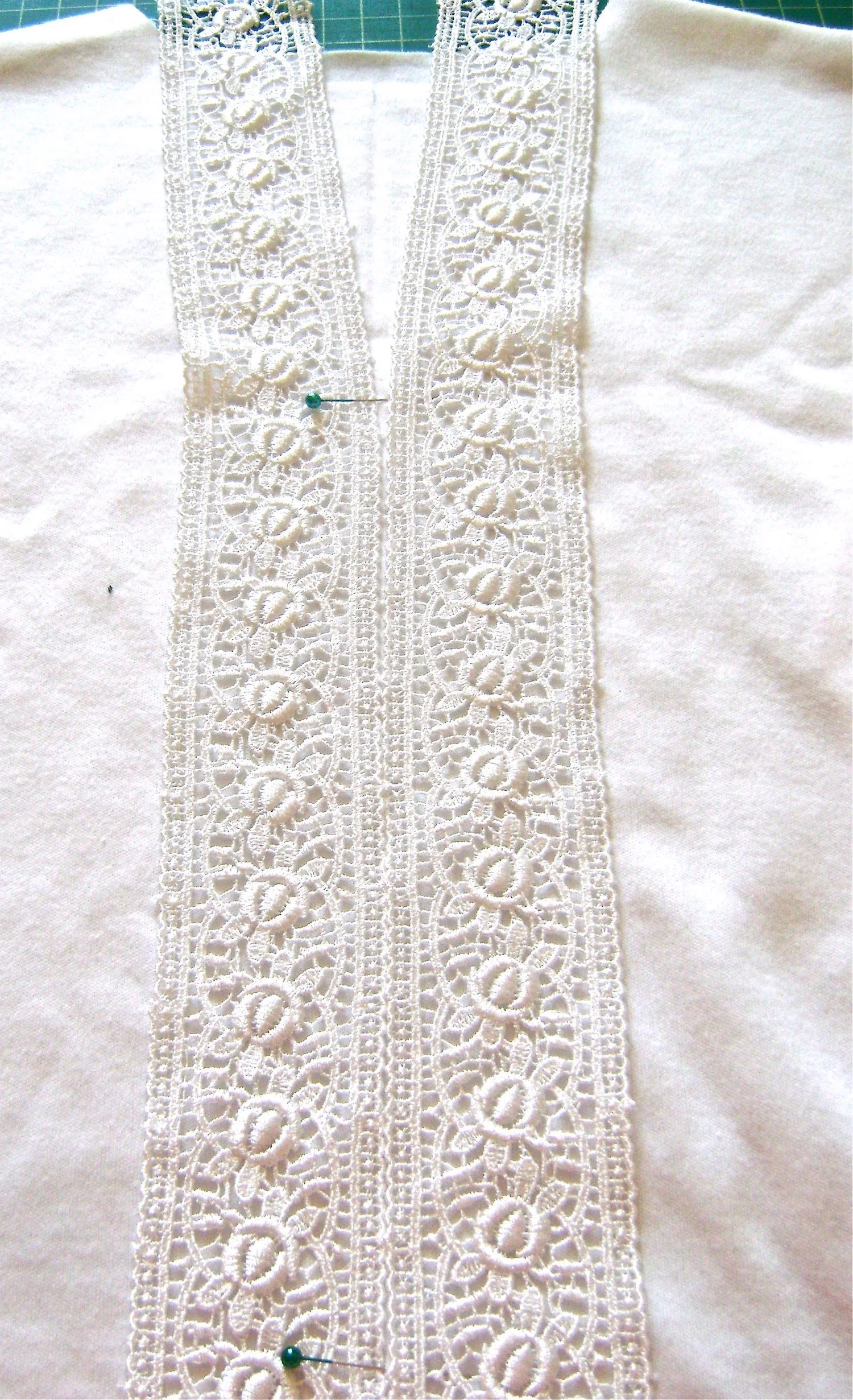 step 4 - Temporarily place two pieces of lace side by side down the front of the shirt with the long lace edges meeting on the crease. 