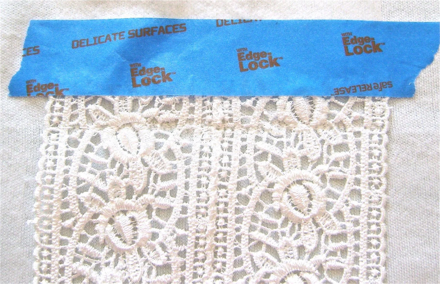 step 11 - Use a fine zigzag stitch to join the two lace strips stopping at the top opening. Position the joined lace strips on the center of the shirt 2.5” above the waistline. With the right side of the lace against the right side of the shirt pin or tape in place. Stitch across the width of lace. Remove the tape and trim the lace edge.