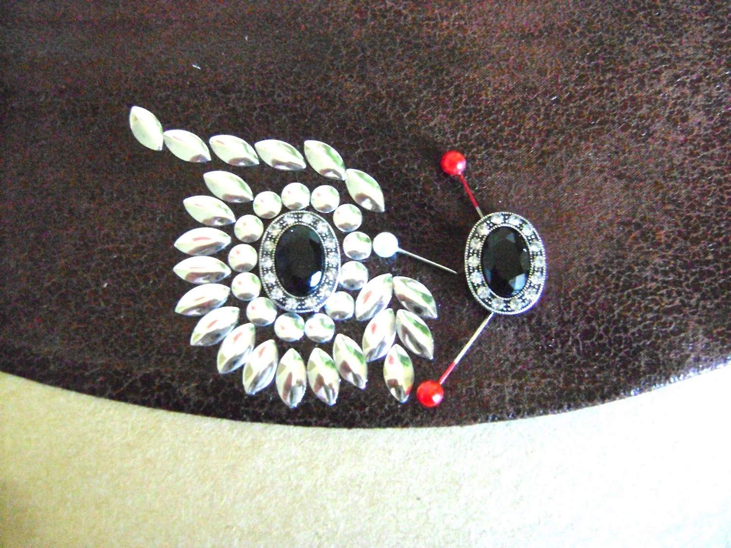 step 14 - Work on the right side eye and eyebrow following the same steps. Glue the eyes to the fabric and allow to dry.