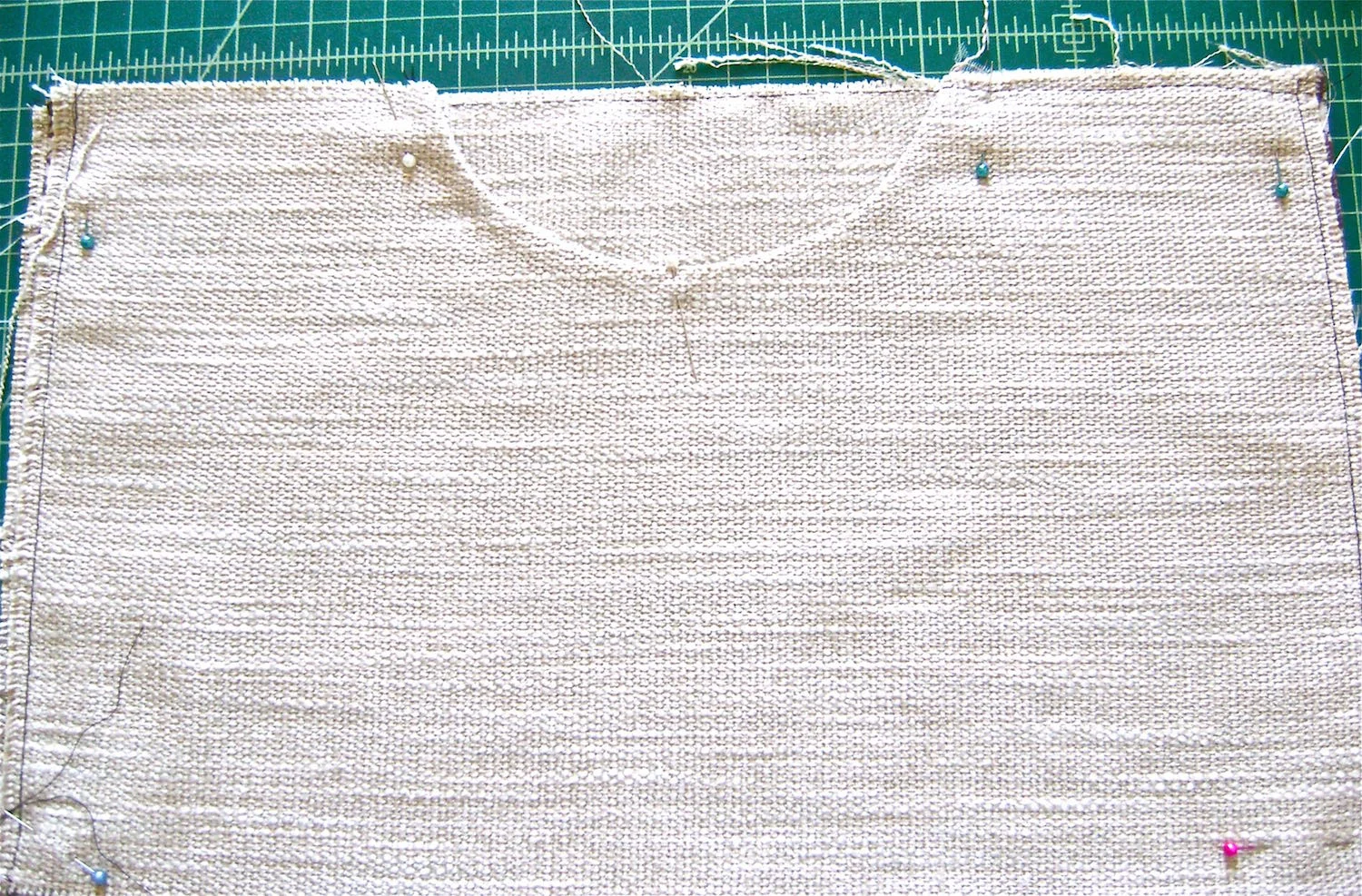 step 2 - Pockets Use the template to cut out the pocket opening shape. Sew the linings to the pocket pieces right sides together with stay tape on the 5/8” seam line. Topstitch seam allowance to the lining. Trim the seam allowance. Press with wrong sides together. Align the top of the front pocket to the top of the woven fabric with the lining against the right side of the woven fabric. Machine baste the top edge and sides.