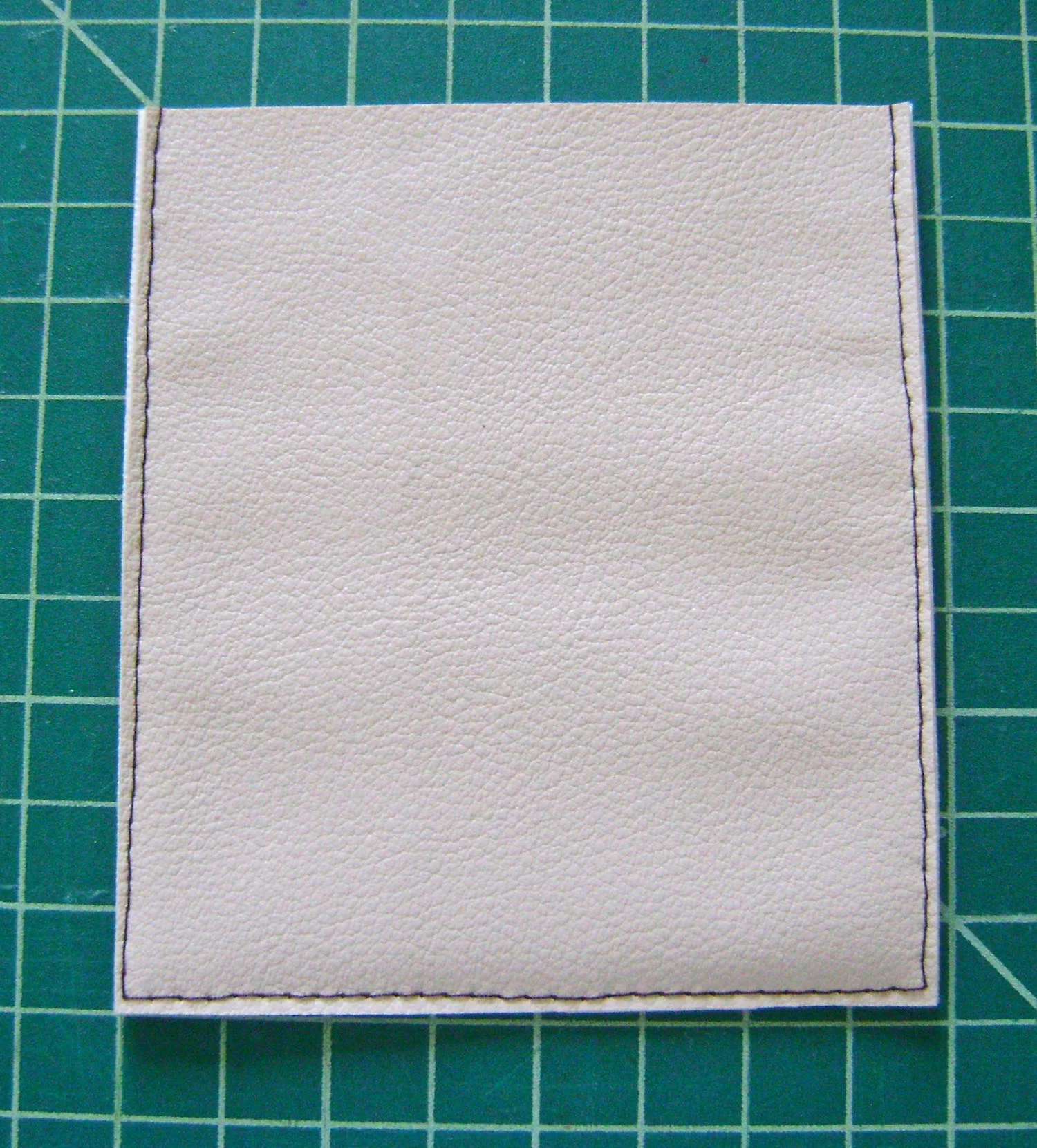 step 7 - Clasp Flap With wrong sides together stitch three sides .25” from the raw edge. Cut close to stitching to create a tiny clean edge. 