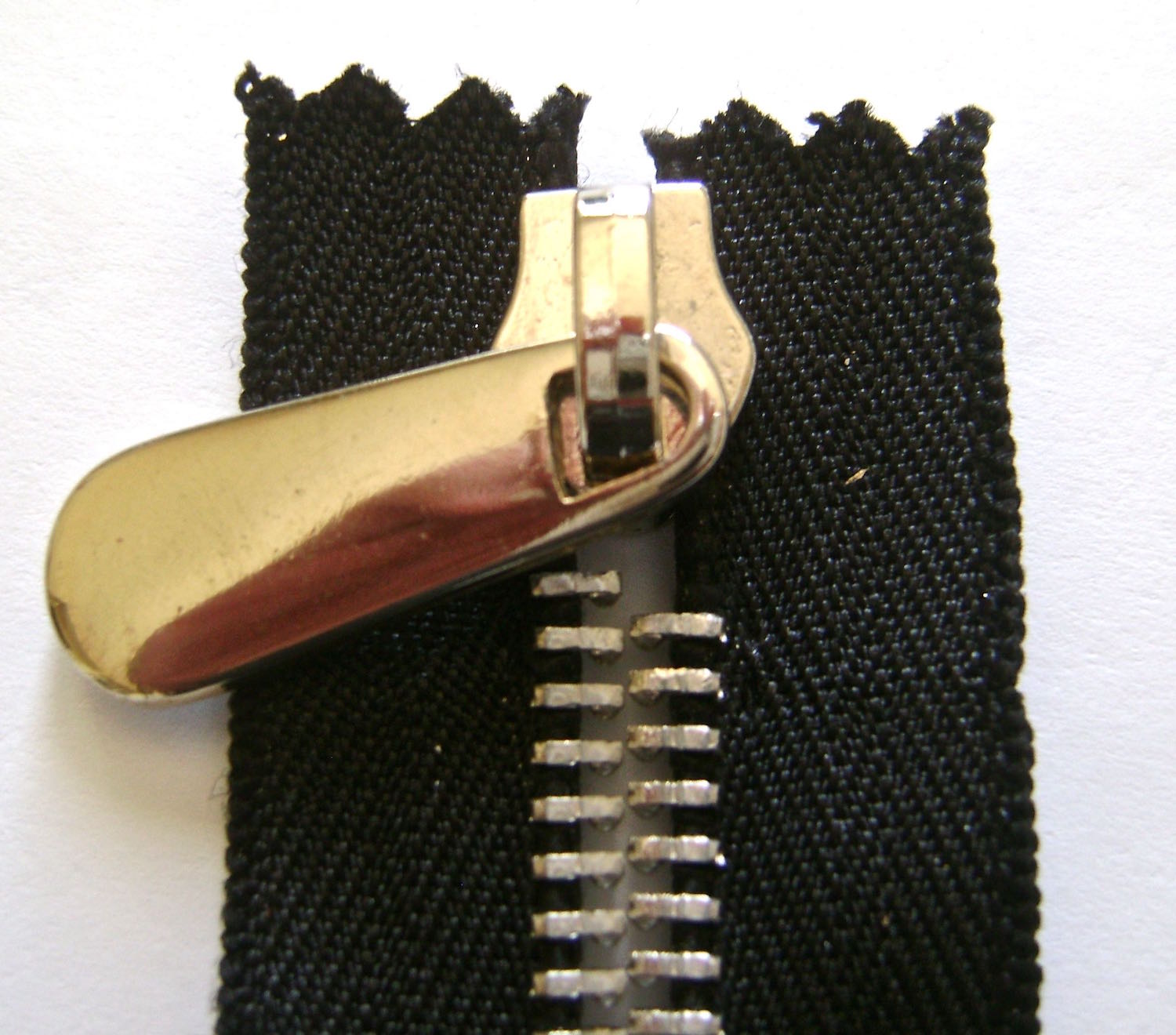 step 6 - Slide on the new zipper pulls. 