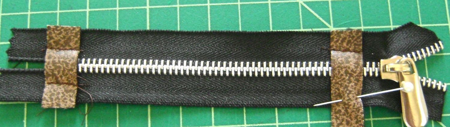 step 7 - Sew both sides of the stop pieces at the bottom end of the zipper. You will need to cut away the zipper ends later, so don’t stitch all the way to the outer edges of the stops (red circles). Sew only enough stitches to hold the stops in place. Sew one side of the stop at the top of the zipper. 