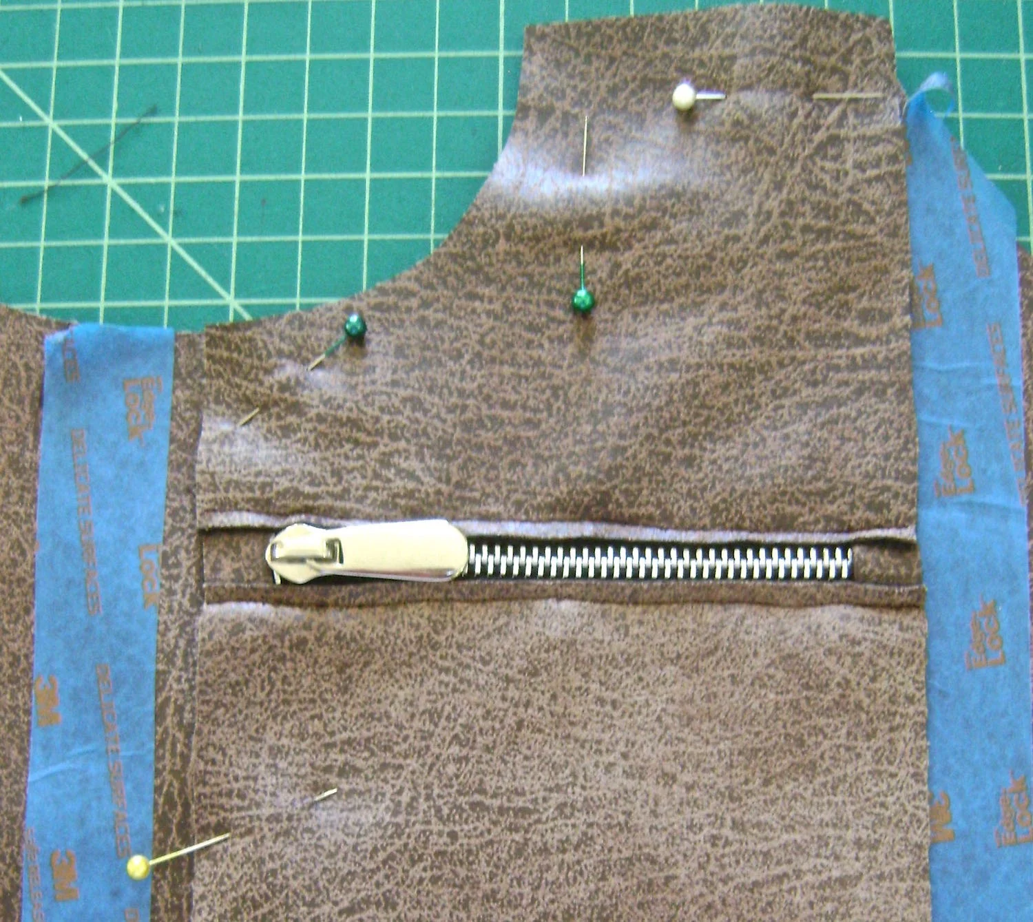 step 11 - Align zippered pocket pieces to bag at top edge with pocket sides 2.75” from bag sides. There should be approximately 5/8” space in the center between the two zippered pockets.