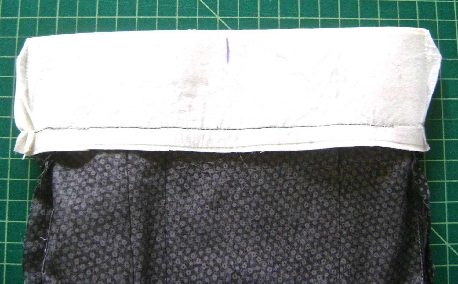 step 11 - With right sides together, stitch the top of the lining to the bottom edge of the purse facing. On the wrong side mark the center of the facing to help with clasp placement later.