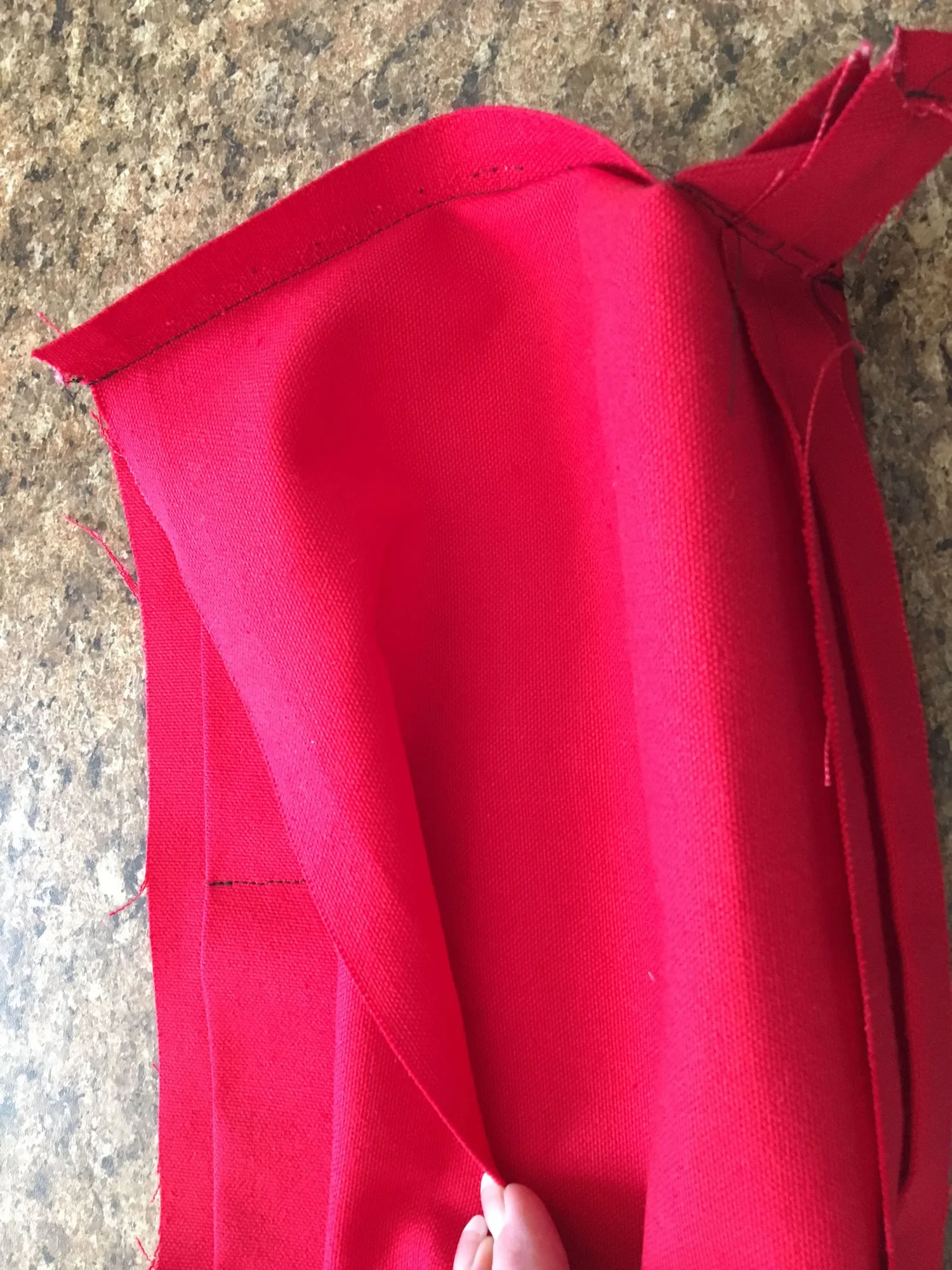 step 15 - Center the pocket inside the lining and sew the pocket to the lining with a 1/8" seam. Pin the right side of the top lining edge to the right top outer edge of the bag. Sew together.