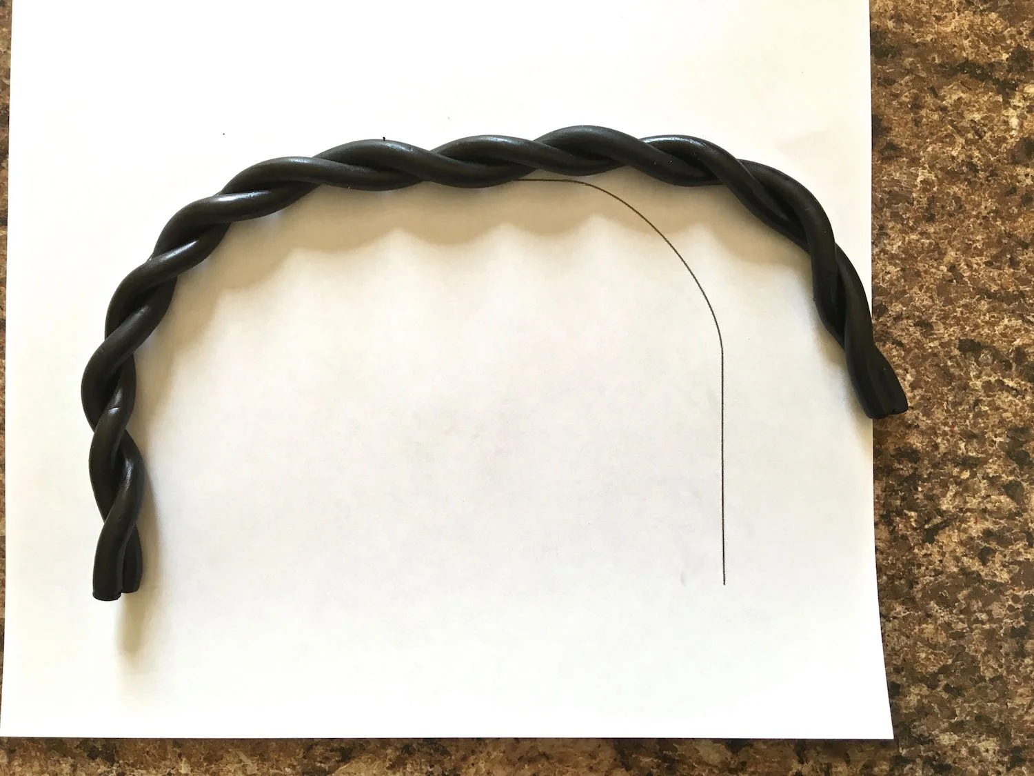step 19 - Print out two bag handle shapes on card stock and lay the twisted clay on the paper matching the curved line.