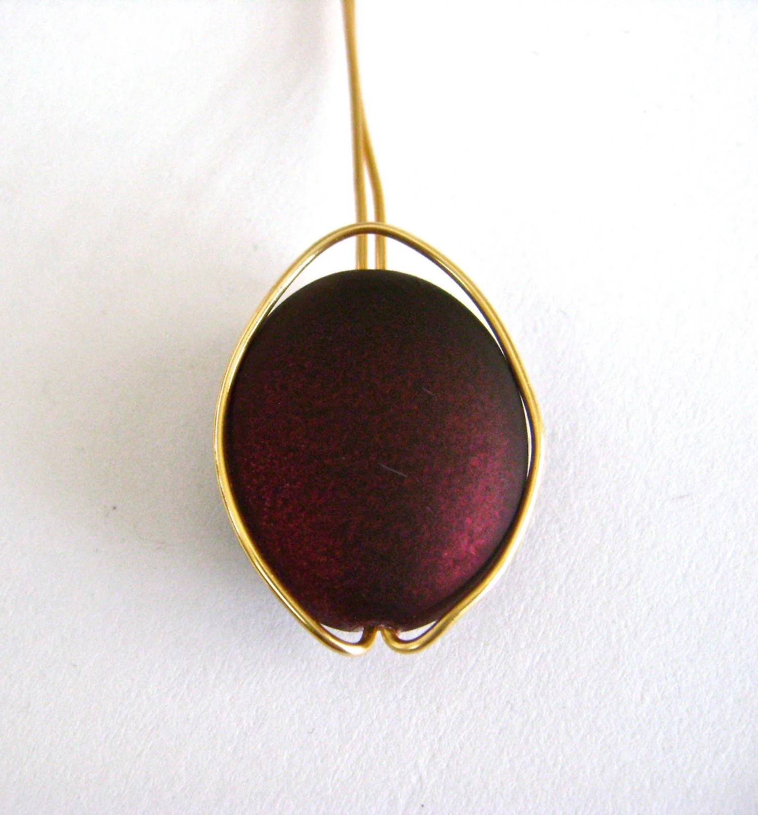 step 3 - Push the loop over the bead to shape the wire to match the oval bead.