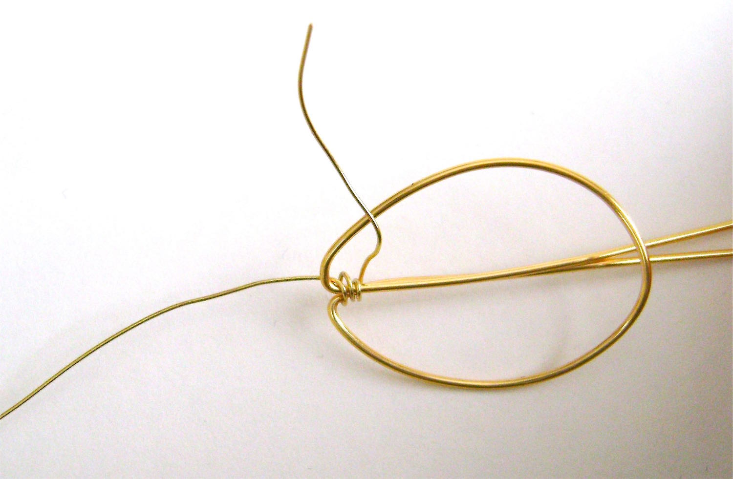 step 5 - Cut a 14” piece of 24 gauge wire. Wrap it around, the two center stems joining them together.