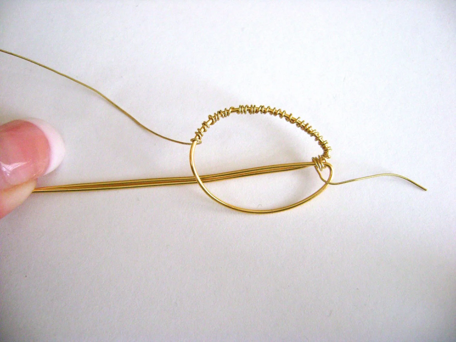 step 6 - Wrap the wire, working around the oval until it is completely covered. Trim the excess 24 gauge wire and smooth the ends.